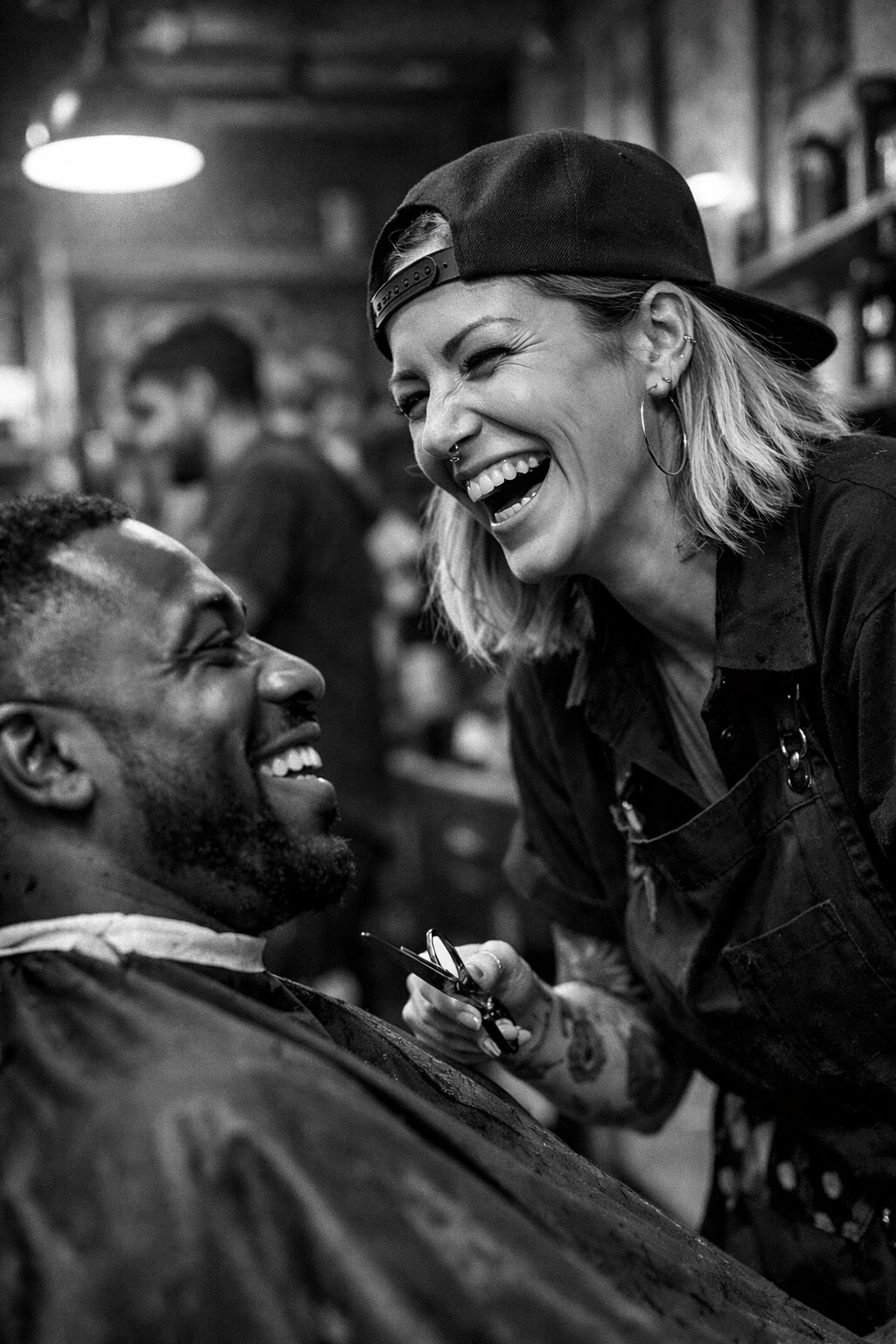 Professional female barber and client interacting at X-Quisite Cutz, showcasing multicultural shop culture.