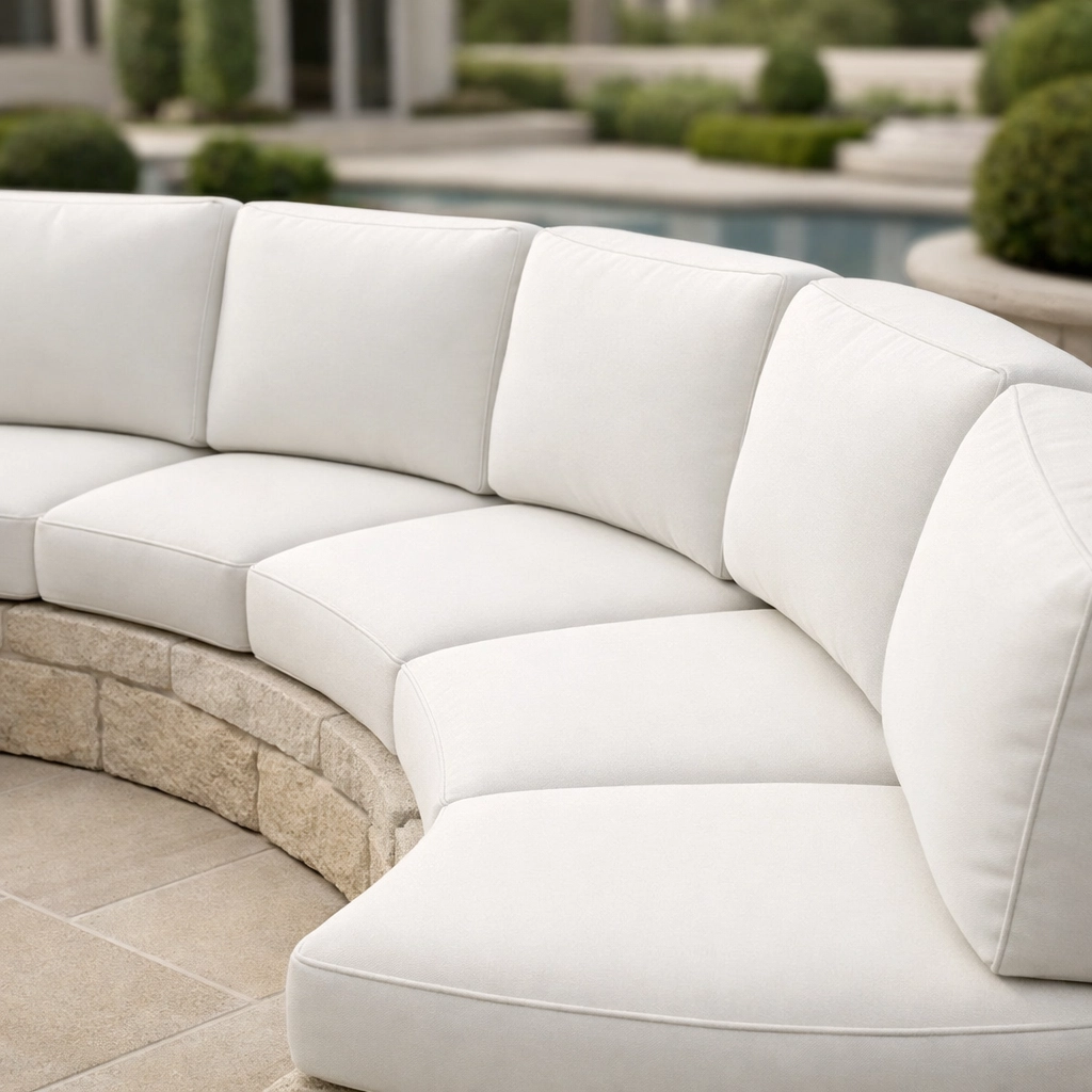 Precision-fitted custom cushions designed for a unique curved stone outdoor sectional sofa.