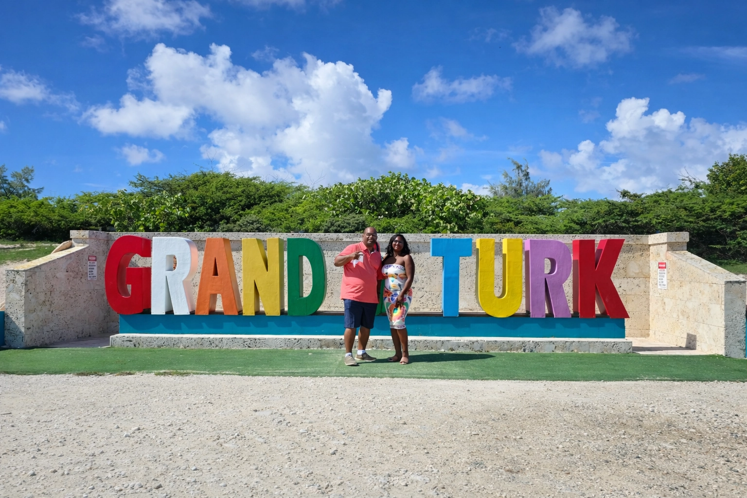 GRAND TURK sign with travelers