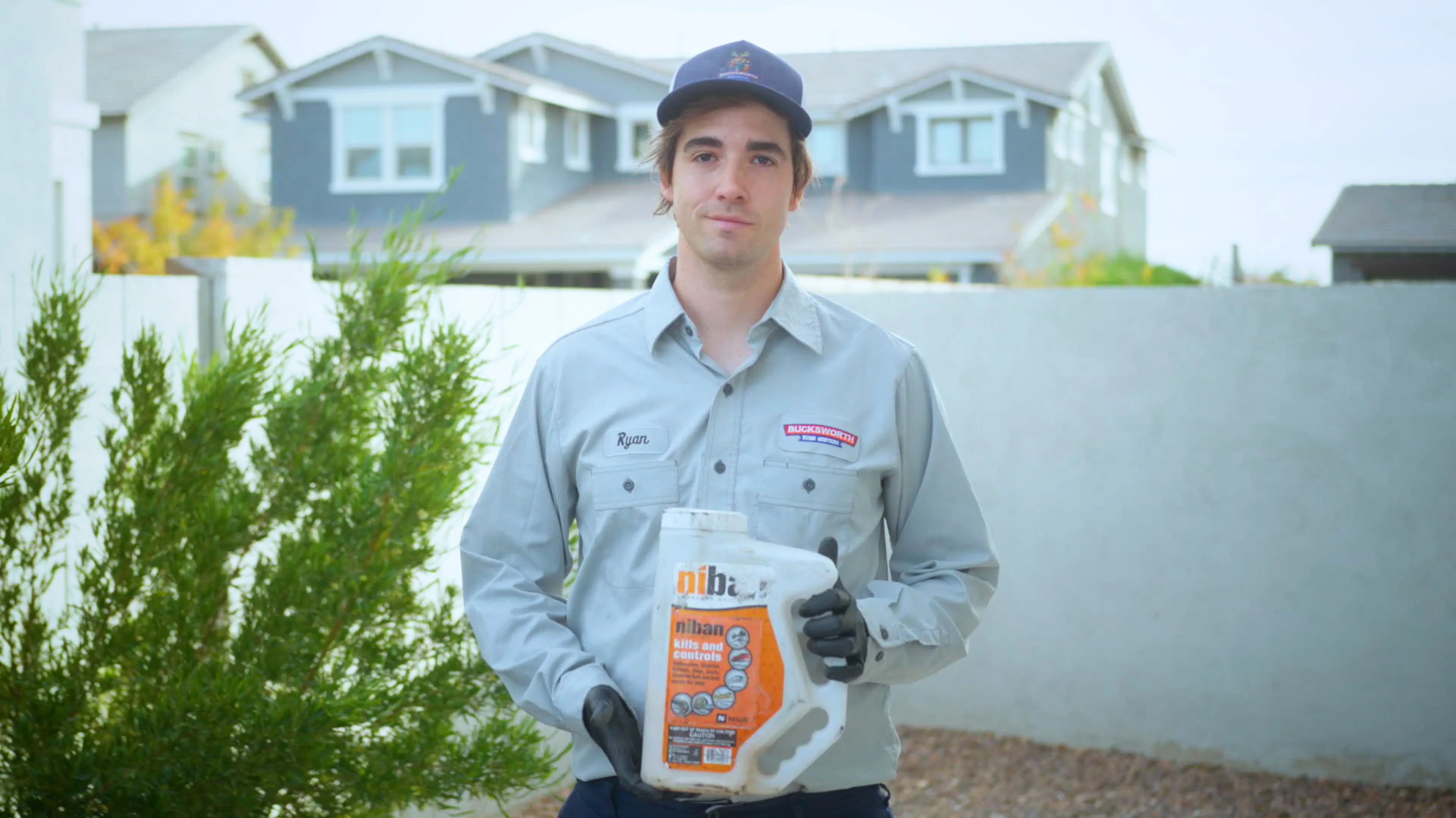 Bucksworth technician holding Niban granular bait outdoors