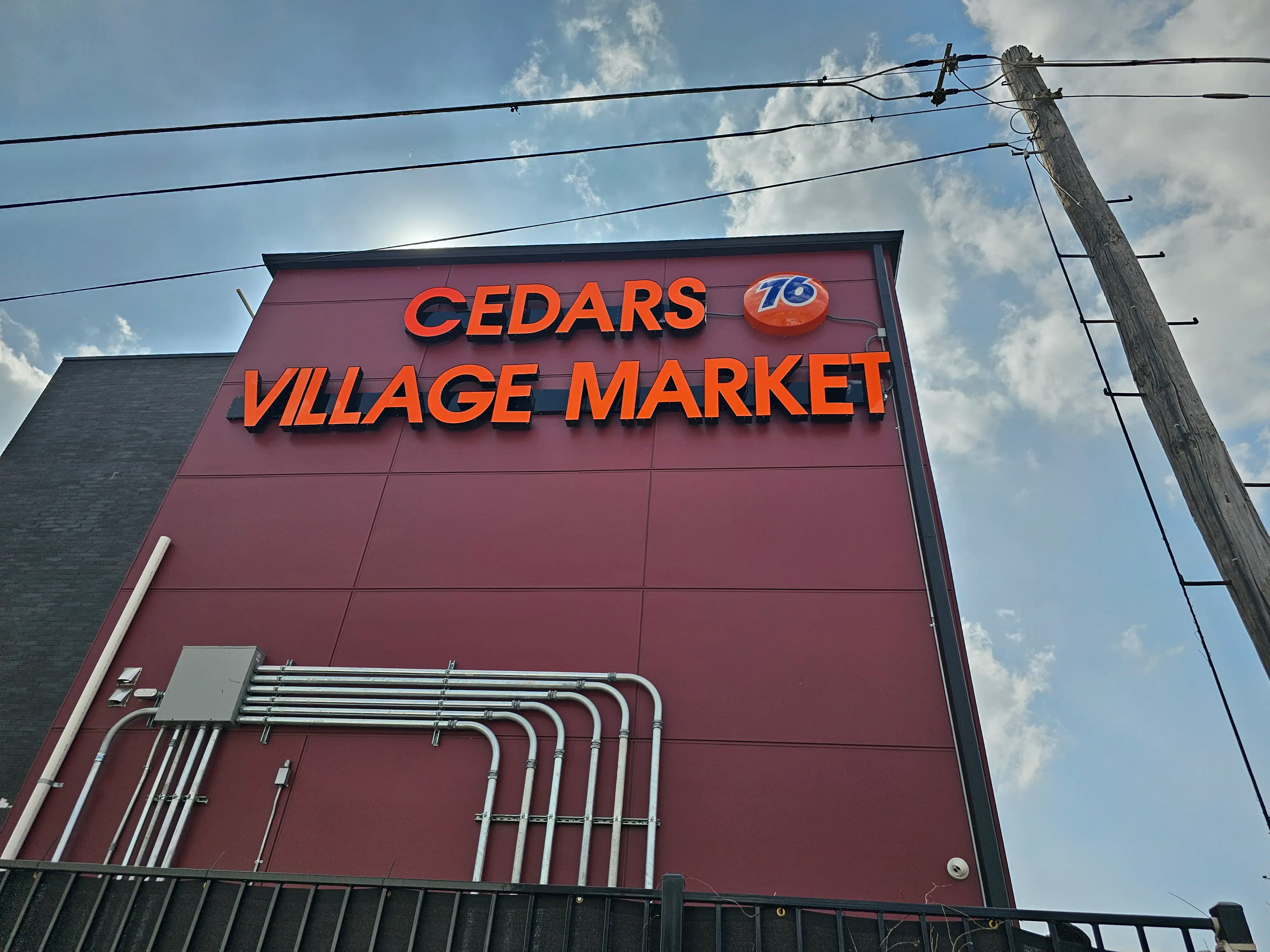 cedars-village-market-led-channel-signage.webp Bright custom LED channel letter sign for “Cedars Village Market” mounted on a red exterior wall