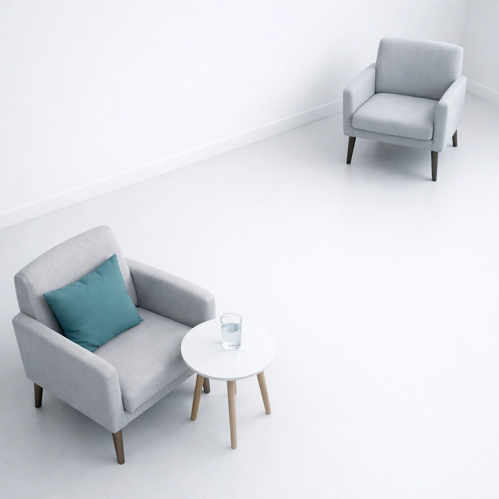 Two therapy chairs at different distances representing family dynamics in addiction recovery