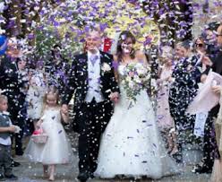 A bride and groom celebrate their wedding surrounded by friends and family