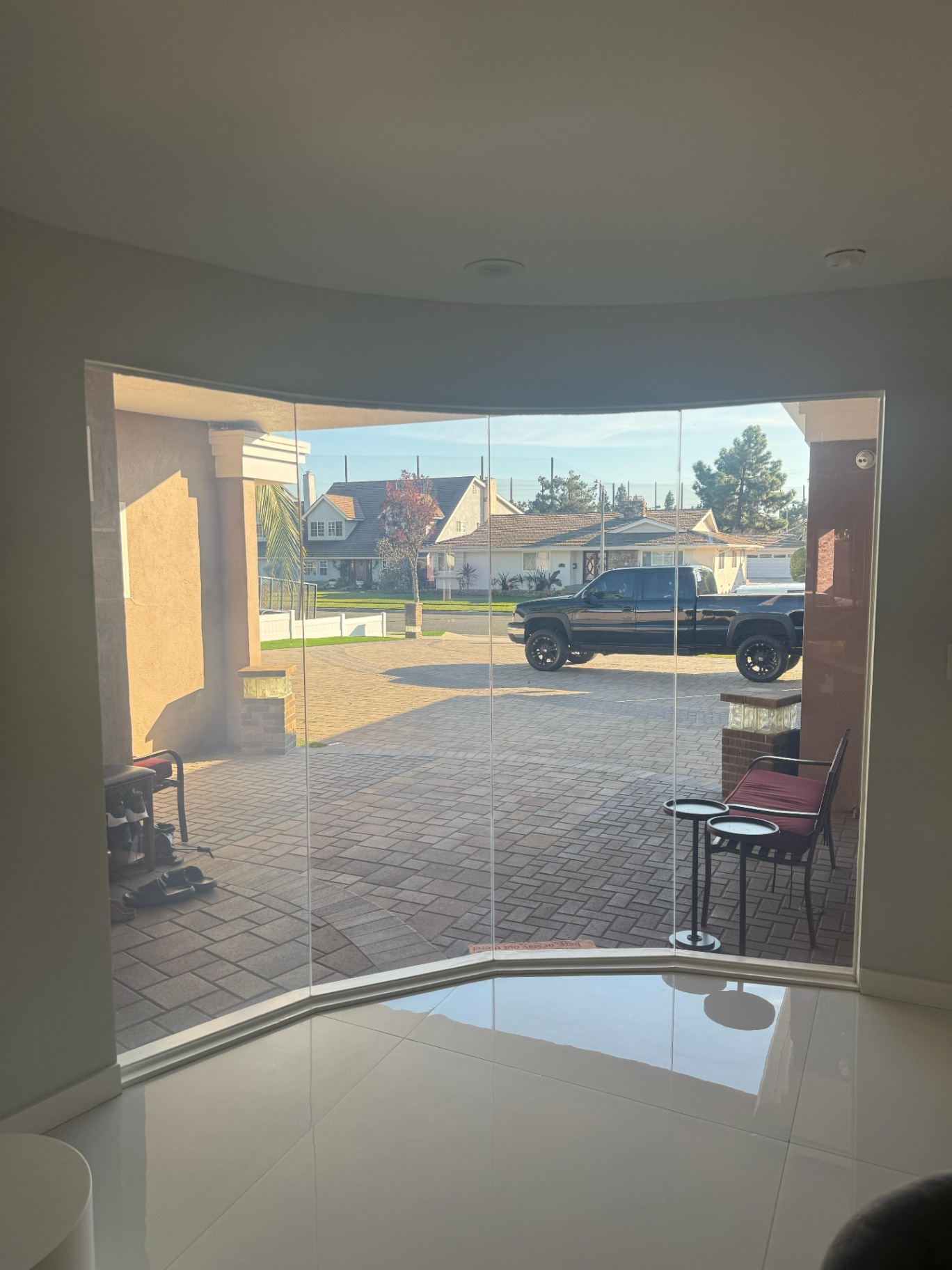 Large curved residential smart glass window in a modern home, showcasing high-end clarity and edge-to-edge installation.