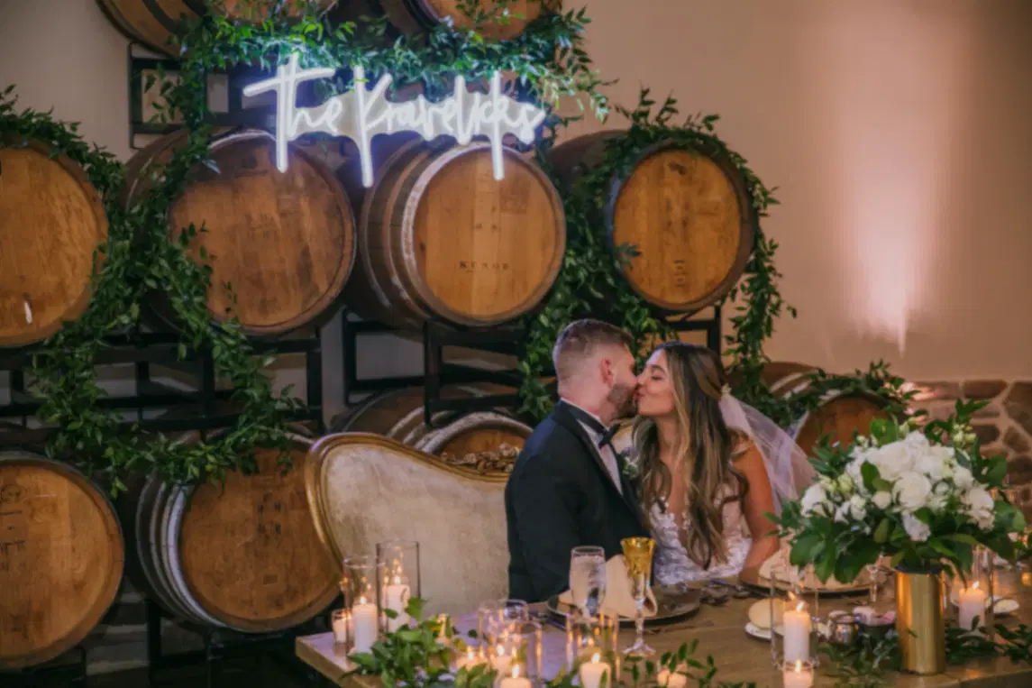 Bride and Groom Sweetheart Table Kiss