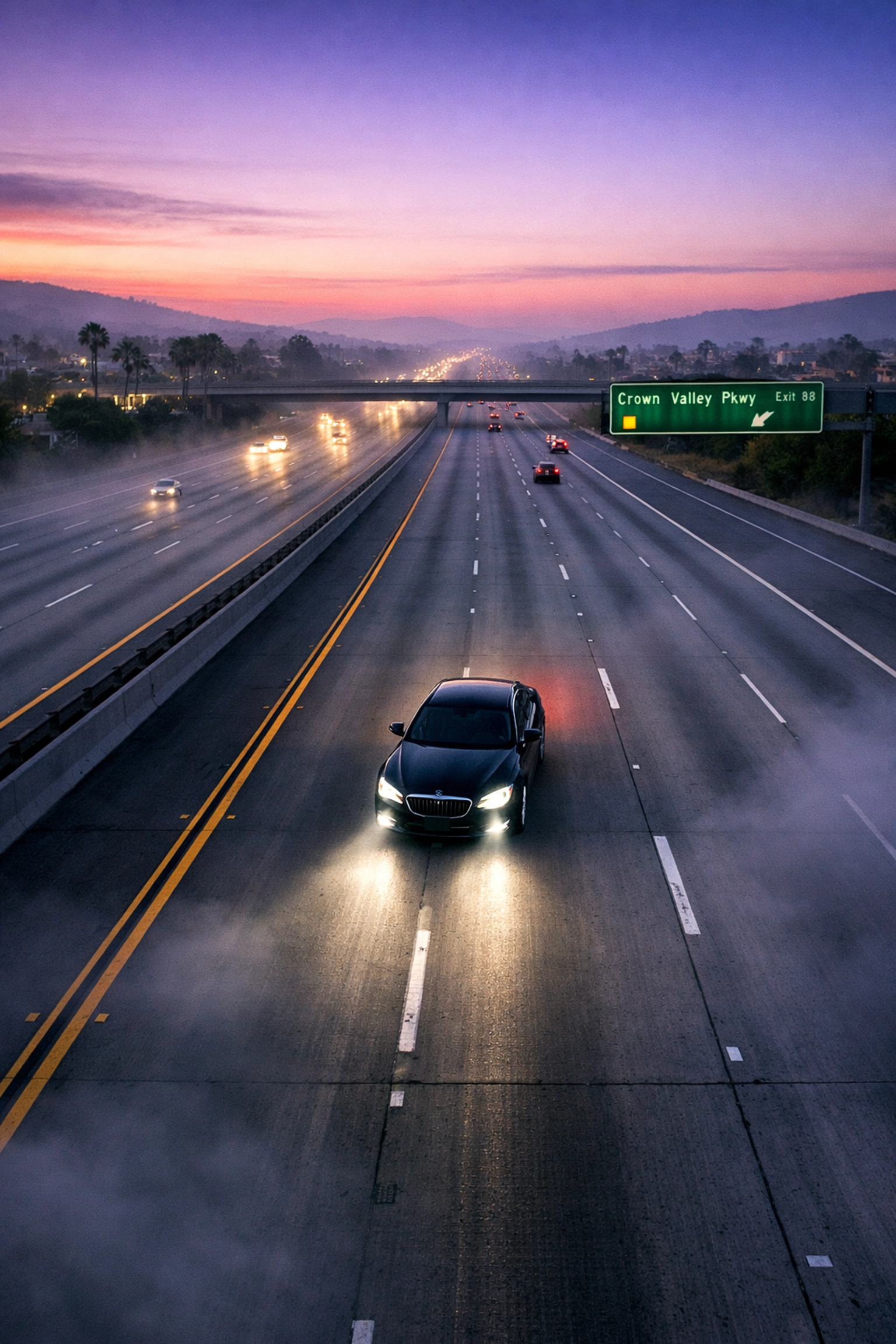 Mission Viejo Executive Car Service & Airport Transportation 1 Luxury black sedan on I-5 freeway during Mission Viejo to LAX airport transfer at dawn