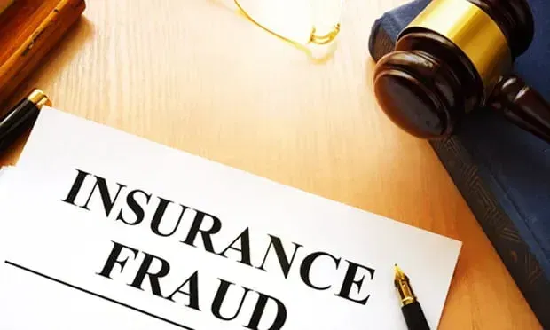 A gavel and insurance fraud documents representing the impact of legislative reforms on Florida home insurance rates.
