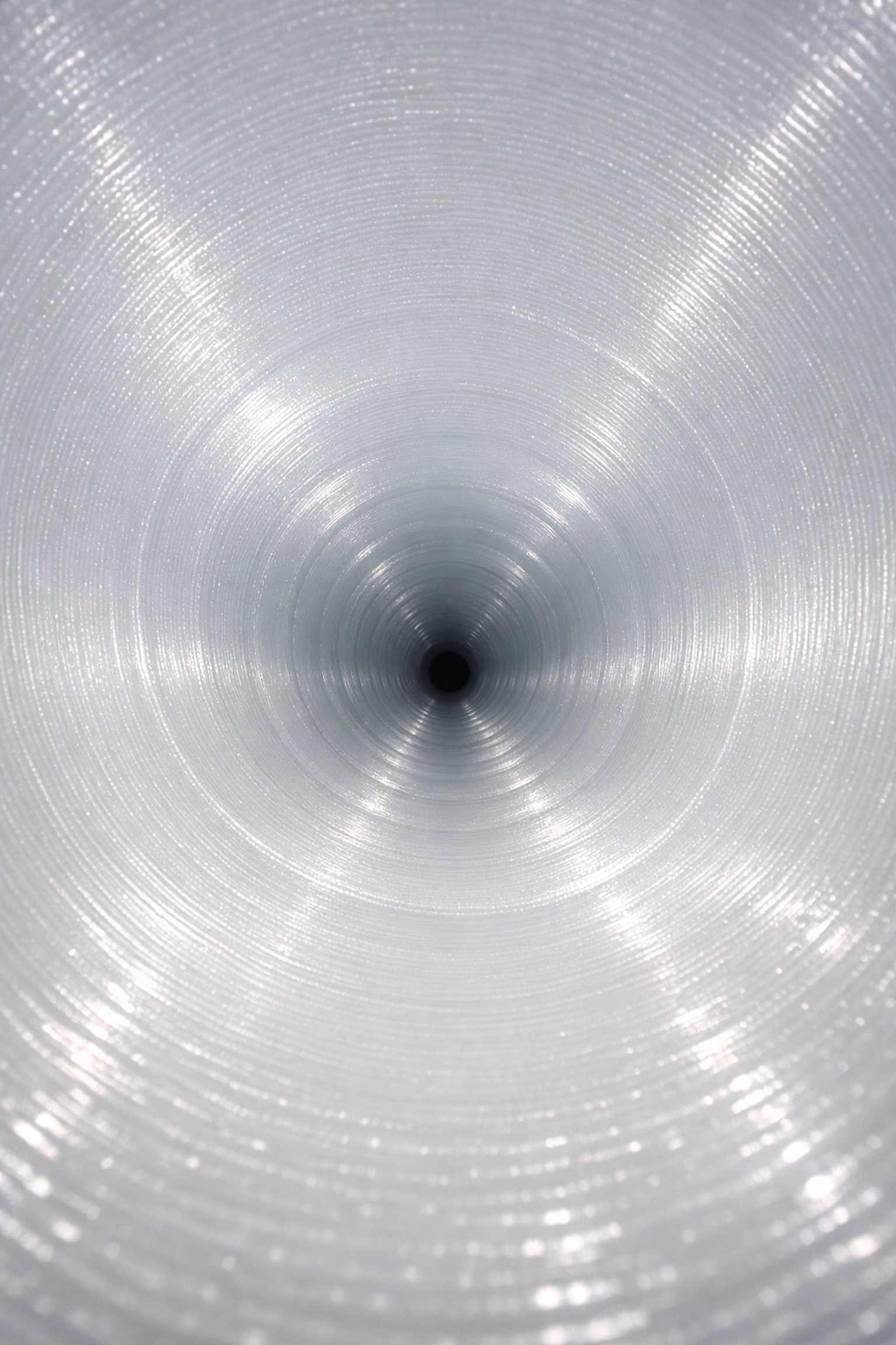 Interior view of a finished UV pipe liner showing a smooth, white, and durable structural repair.