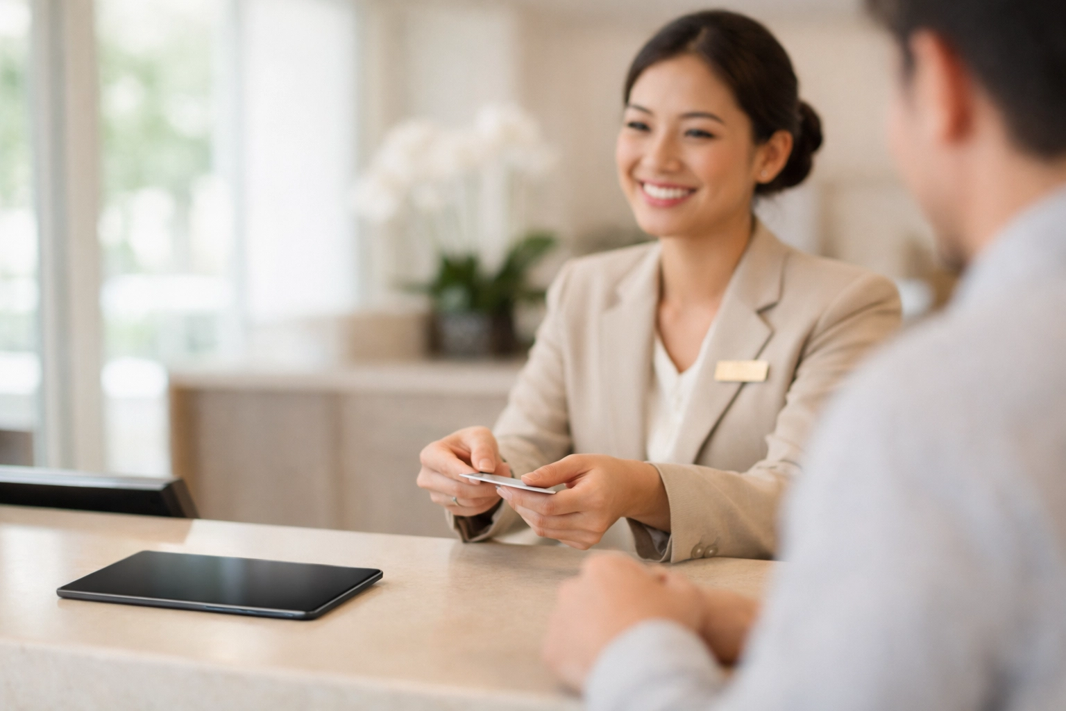 Hotel staff providing personalized guest service at modern reception desk