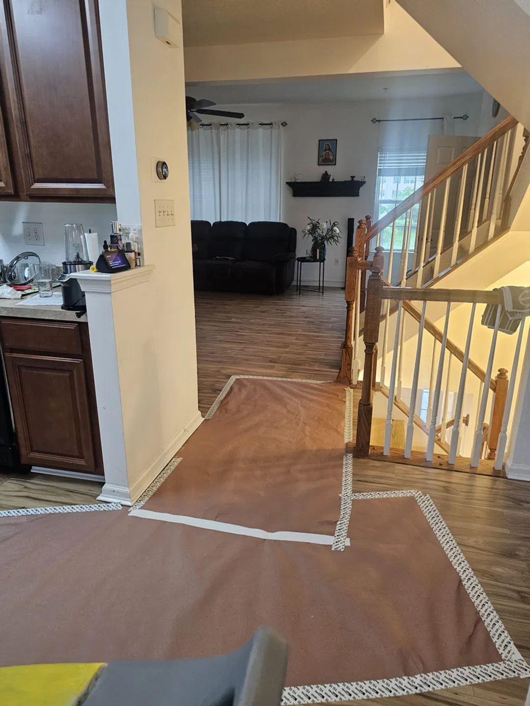 Protective floor covering laid from the kitchen to the living room and staircase to keep floors clean
