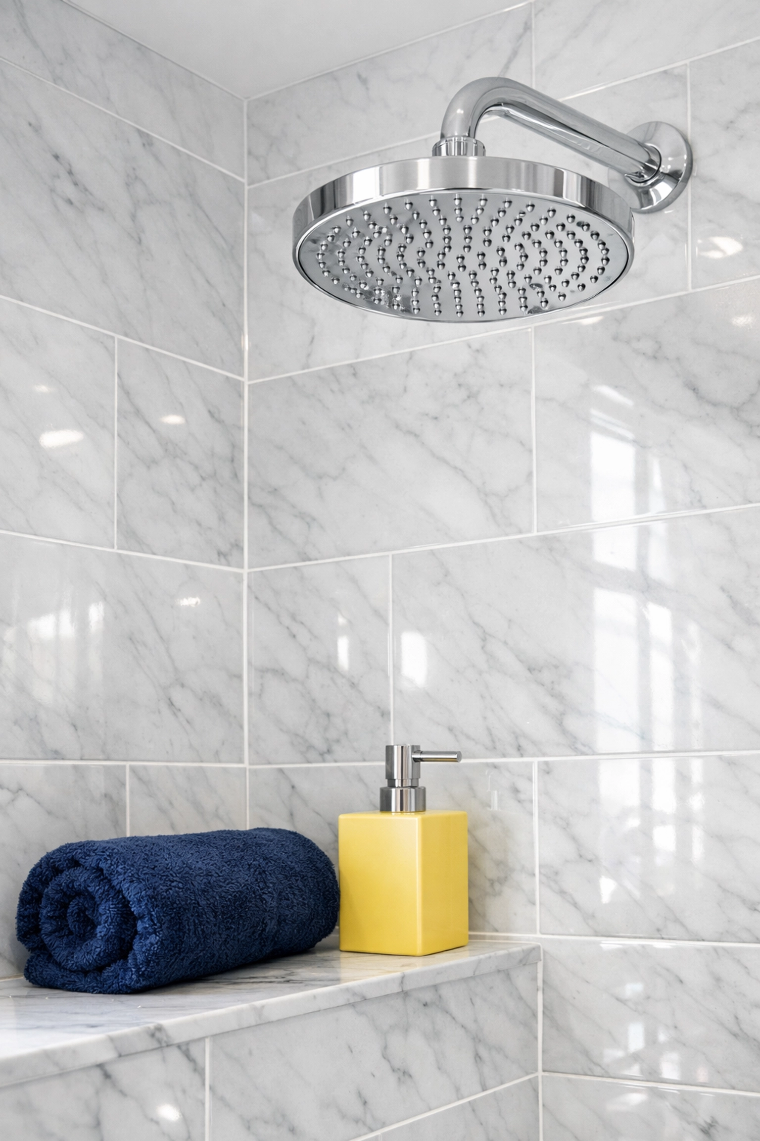 Pristine bathroom in a Bolton home featuring sparkling chrome fixtures and white marble tiles with spotless grout lines.