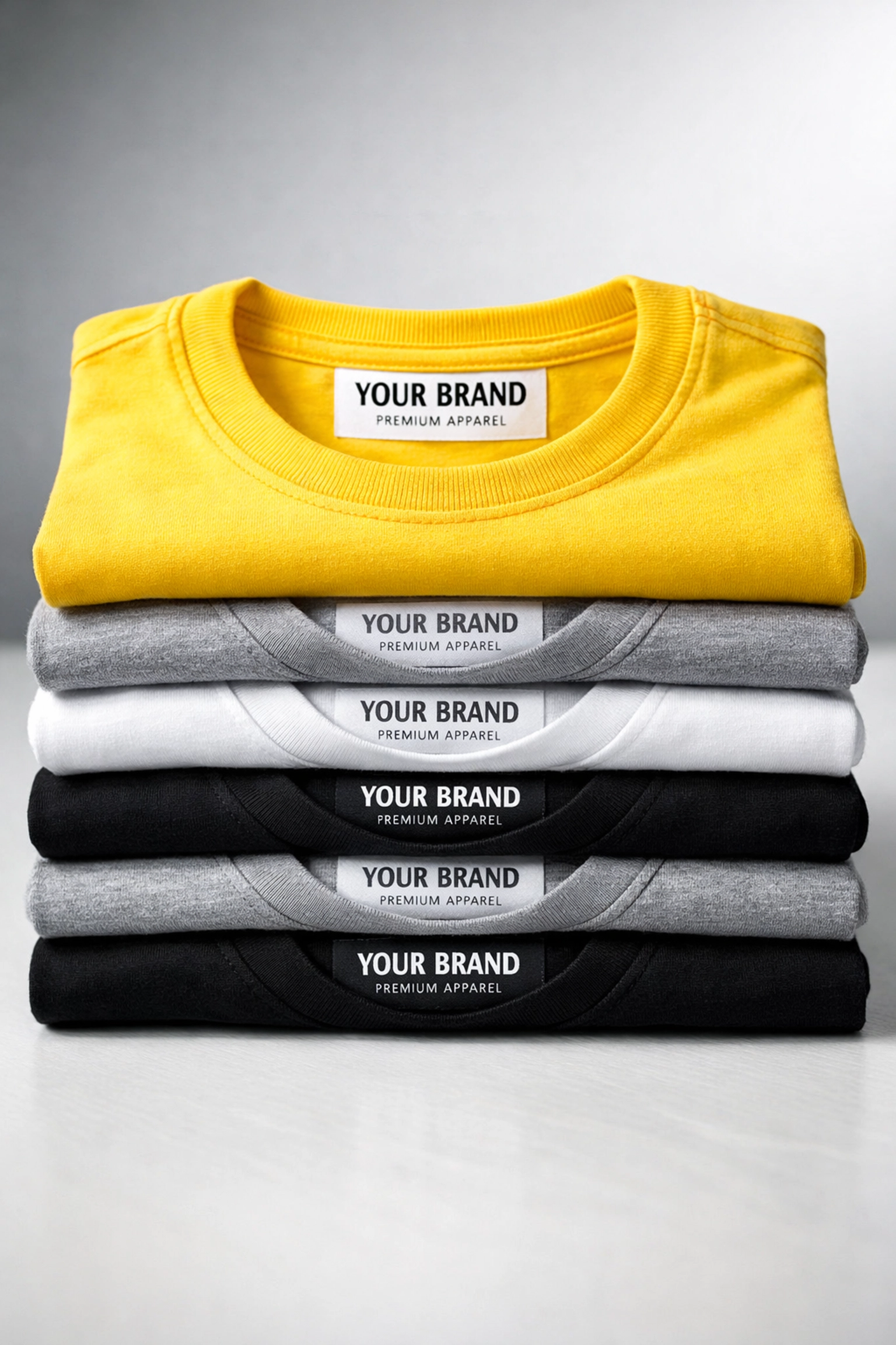 Stack of professionally folded shirts featuring custom branded neck labels for a clothing line.