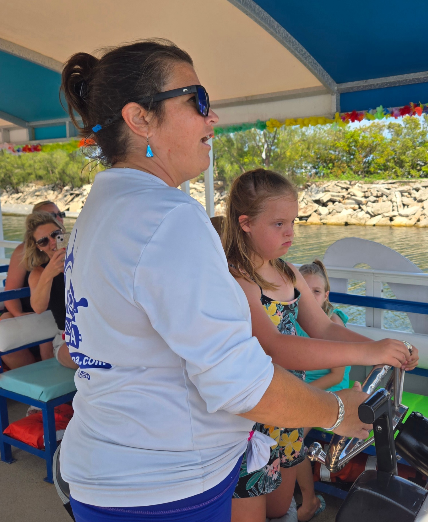 Cruise Cocoa Captain Adventure A Cruise Cocoa captain guides a young guest steering the boat on a sightseeing tour.