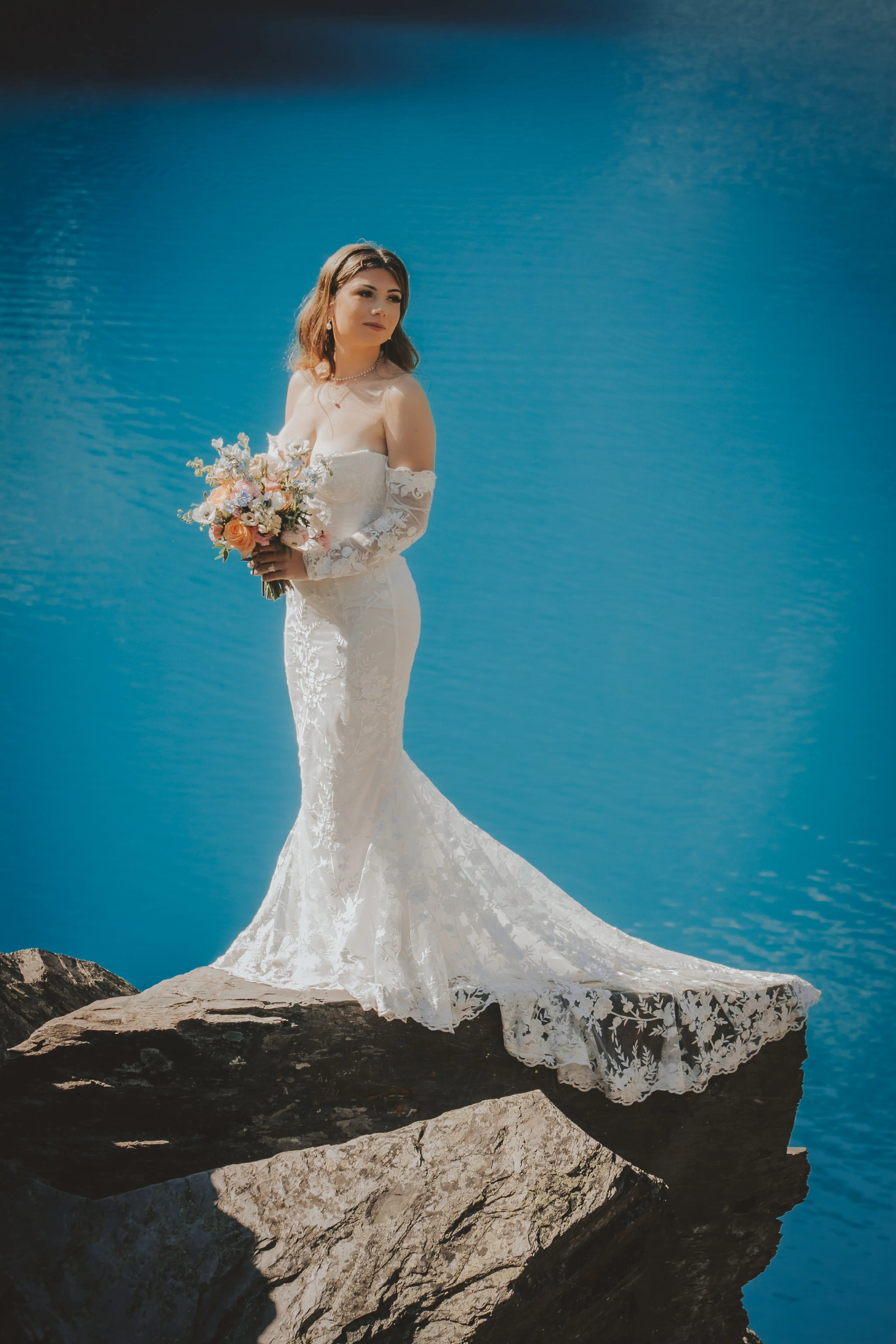 bride-lace-gown-blue-lake-mountain-banff-elopements.webp