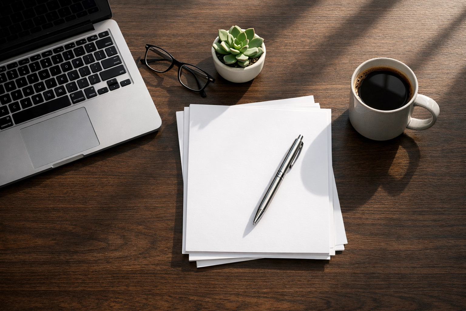 Organized desk with business documents and a laptop, showing preparation for a CSBFL loan application.
