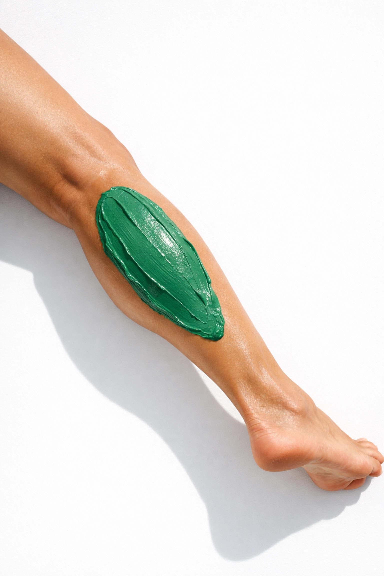 Green Bentonite clay applied to calf muscle as natural alternative to Tiger Balm