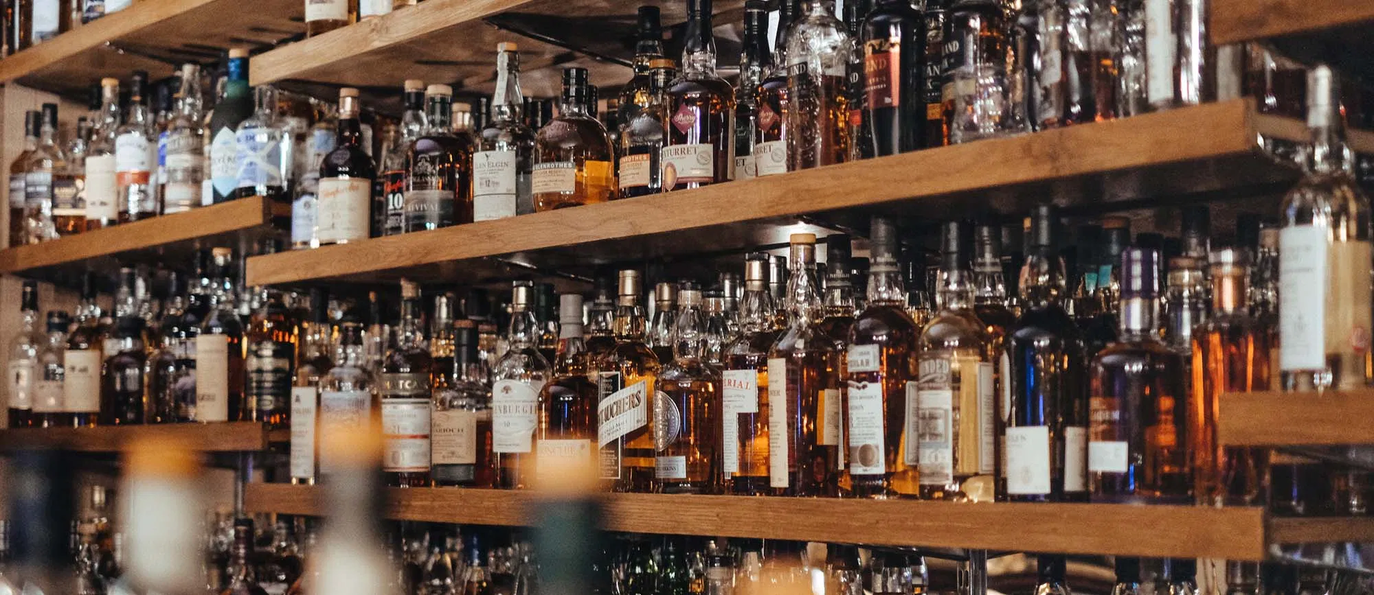 An extensive collection of premium Scottish whisky bottles on display