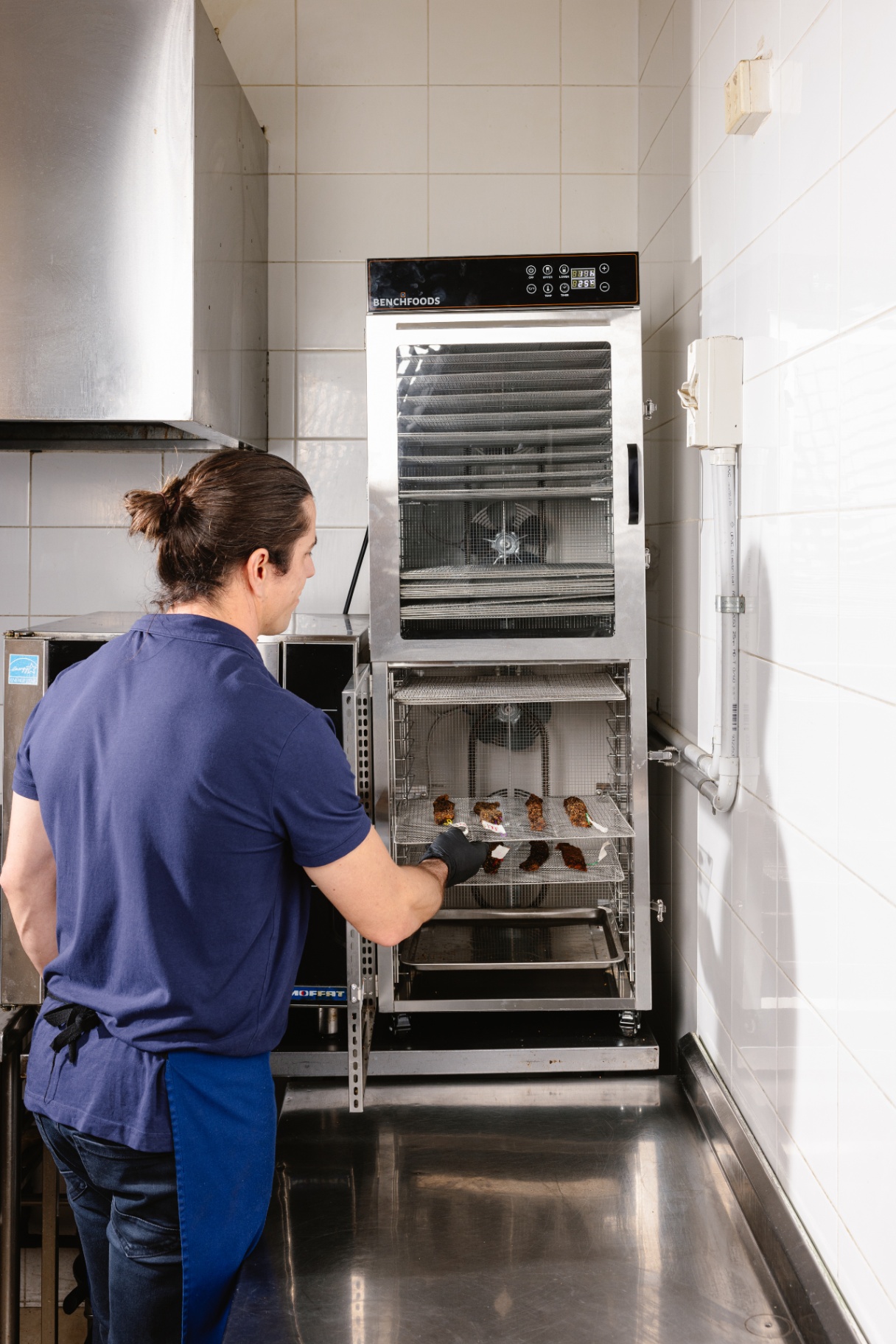 Chef Mark monitoring Australian grass fed beef biltong drying process in commercial dehydrator