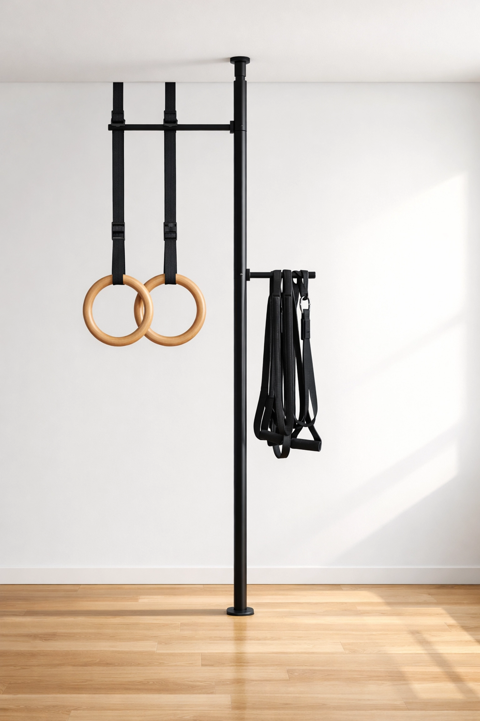 Versatile floor to ceiling gym featuring the Resistance Rail with gymnastic rings and resistance training bands.
