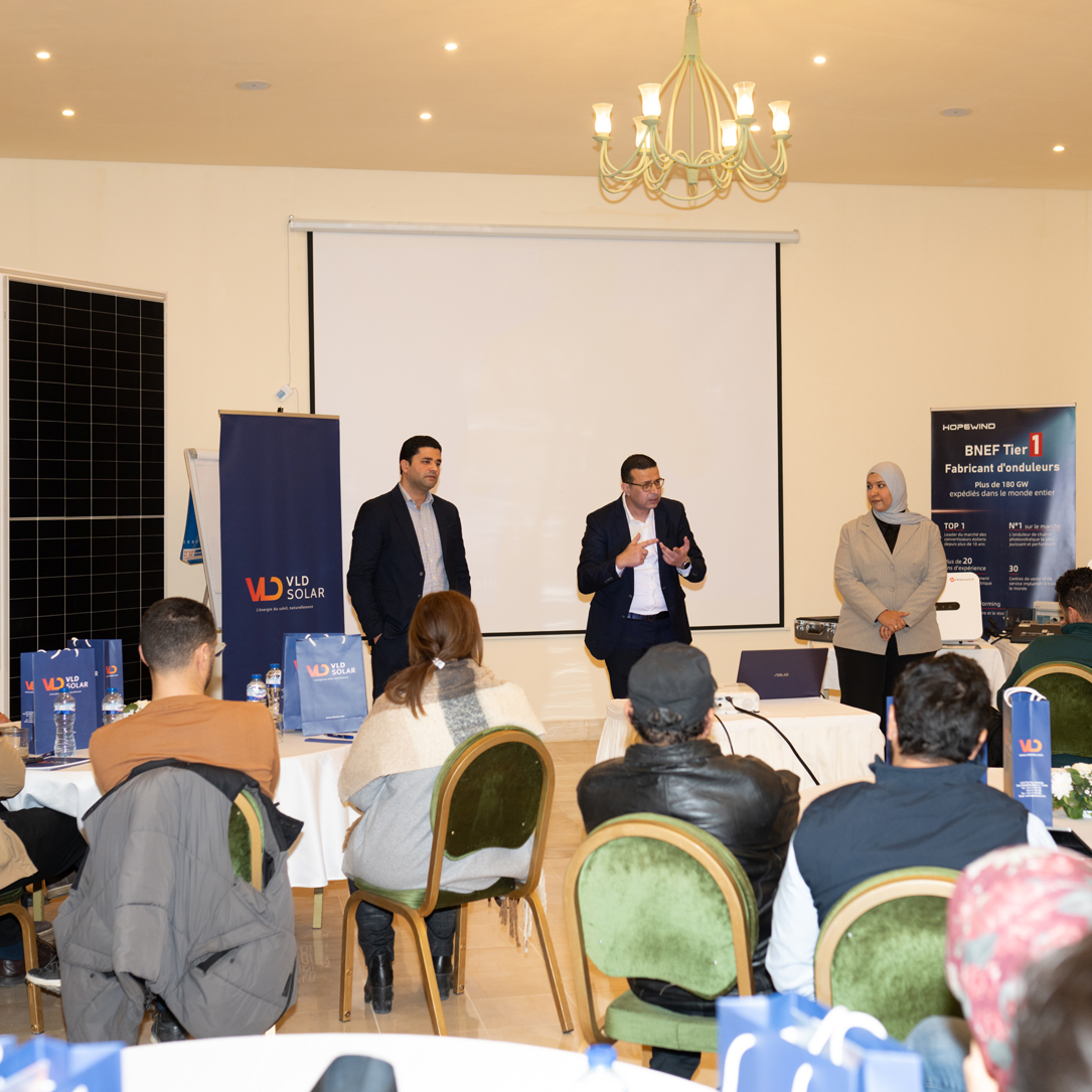 VLD SOLAR team presentation VLD SOLAR team members deliver a presentation to an audience during a professional event. Branding materials, solar panel displays, and partner banners from LONGI and Hope Wind are visible, highlighting the company's focus on solar energy solutions and partnerships with top industry brands.