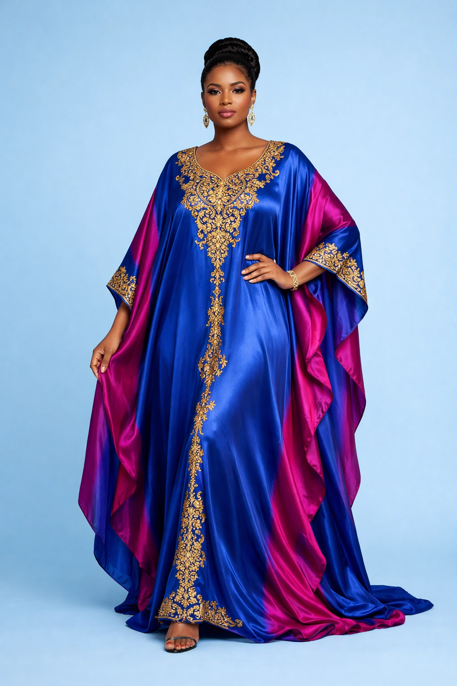 Elegant woman wearing a luxury silk Boubou dress with intricate gold embroidery.