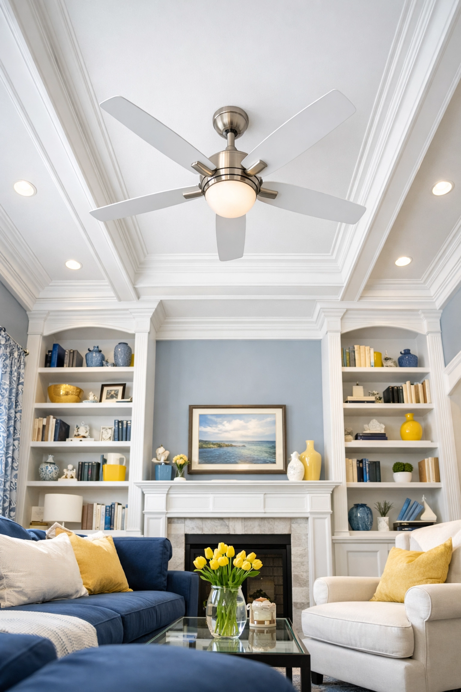 Clean living room with high ceilings and bookshelves maintained by house cleaning in Townsend MA.