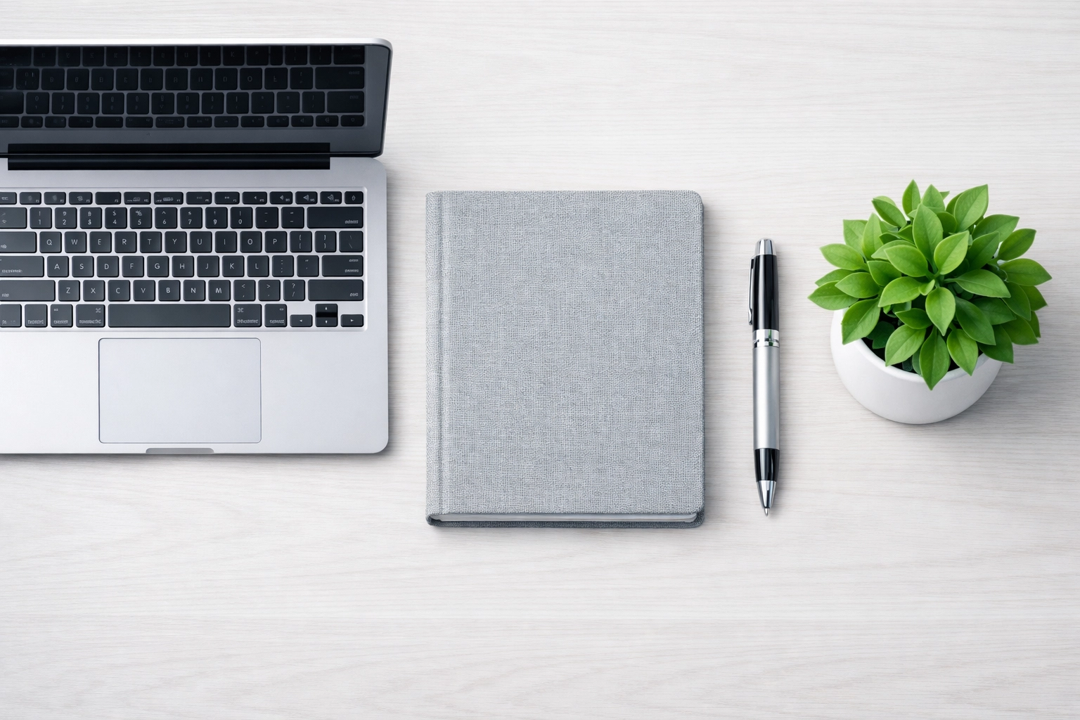 Laptop and notebook illustrating organized financial records and documentation for selling an Alabama cleaning business.