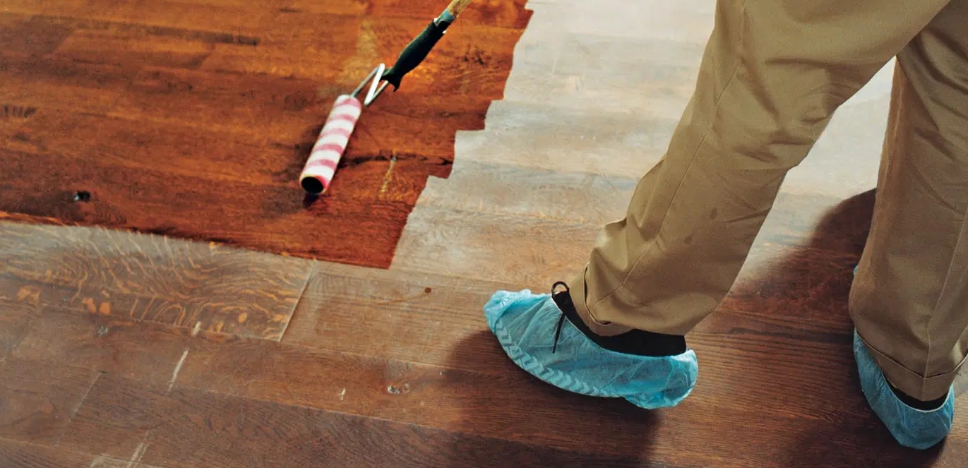 Technician Refinishing Hardwood Floor
