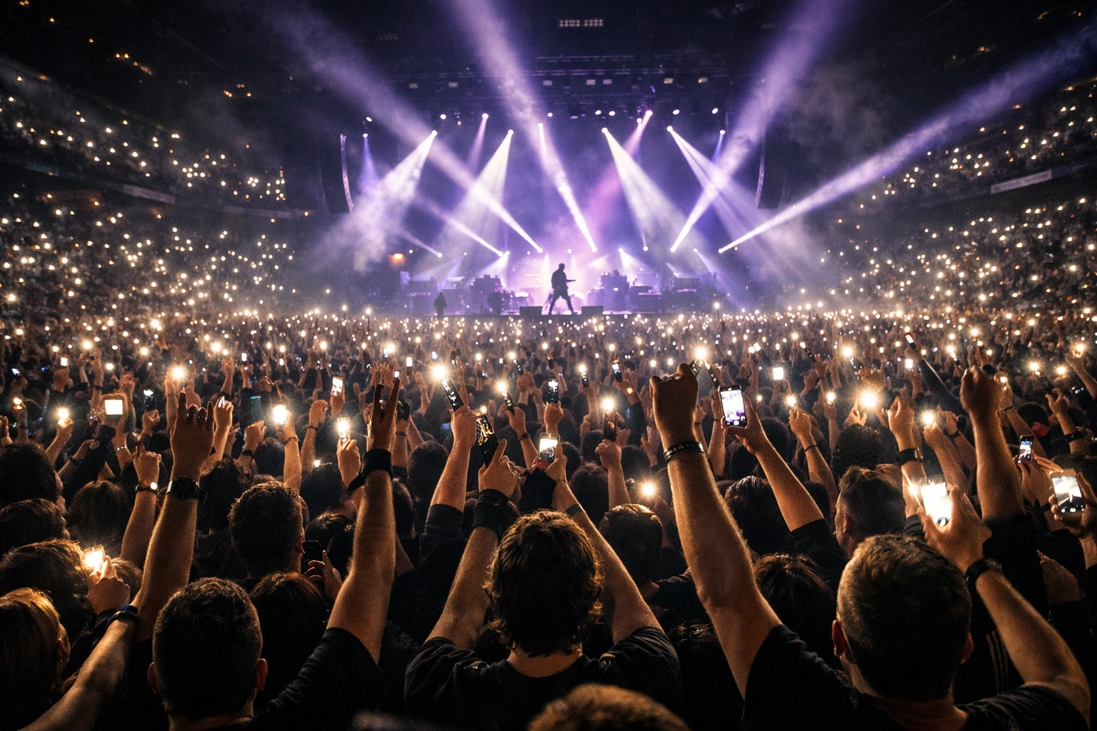 Concert crowd with raised hands and phone lights at 3 Doors Down rock show