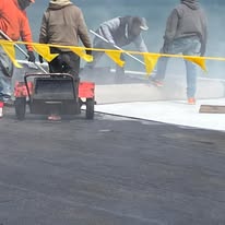 Commercial Roofing Crew Installing Flat Roof Membrane
