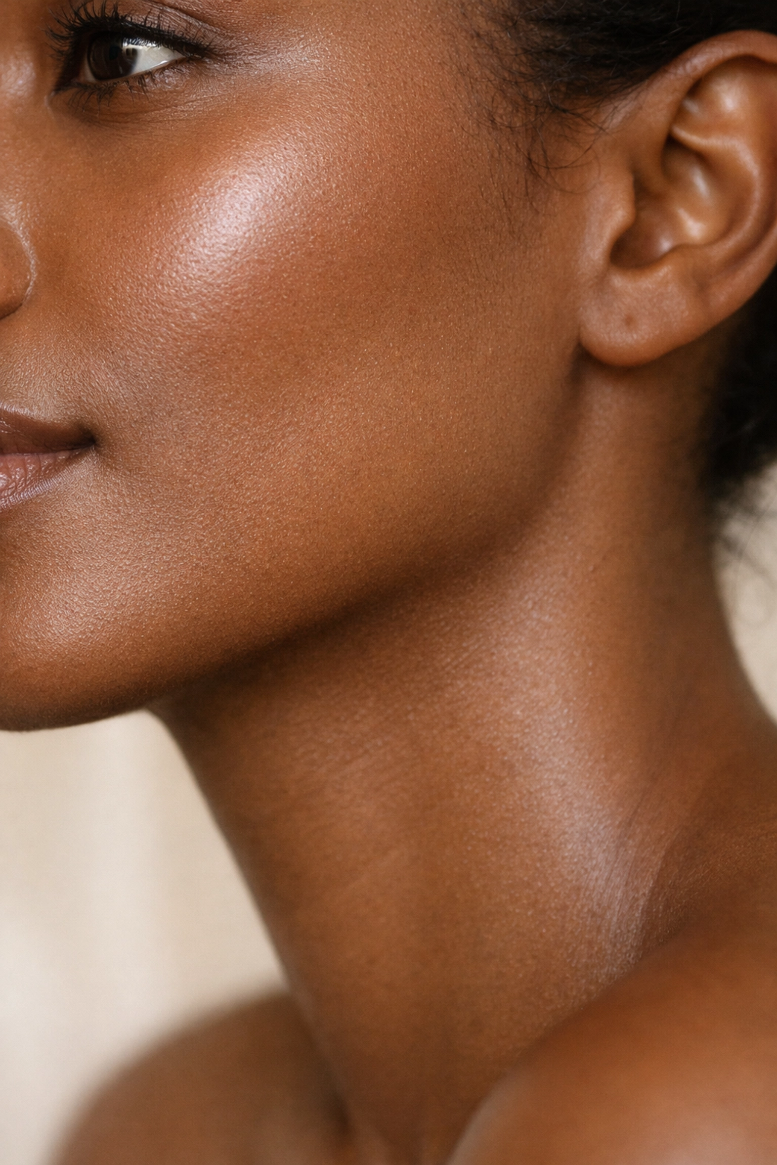 Woman with smooth glowing skin of colour showing results safe for melanin-rich skin tones