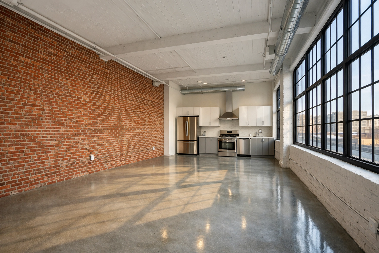 Clean Detroit industrial loft apartment turnover featuring modern kitchen and polished floors.