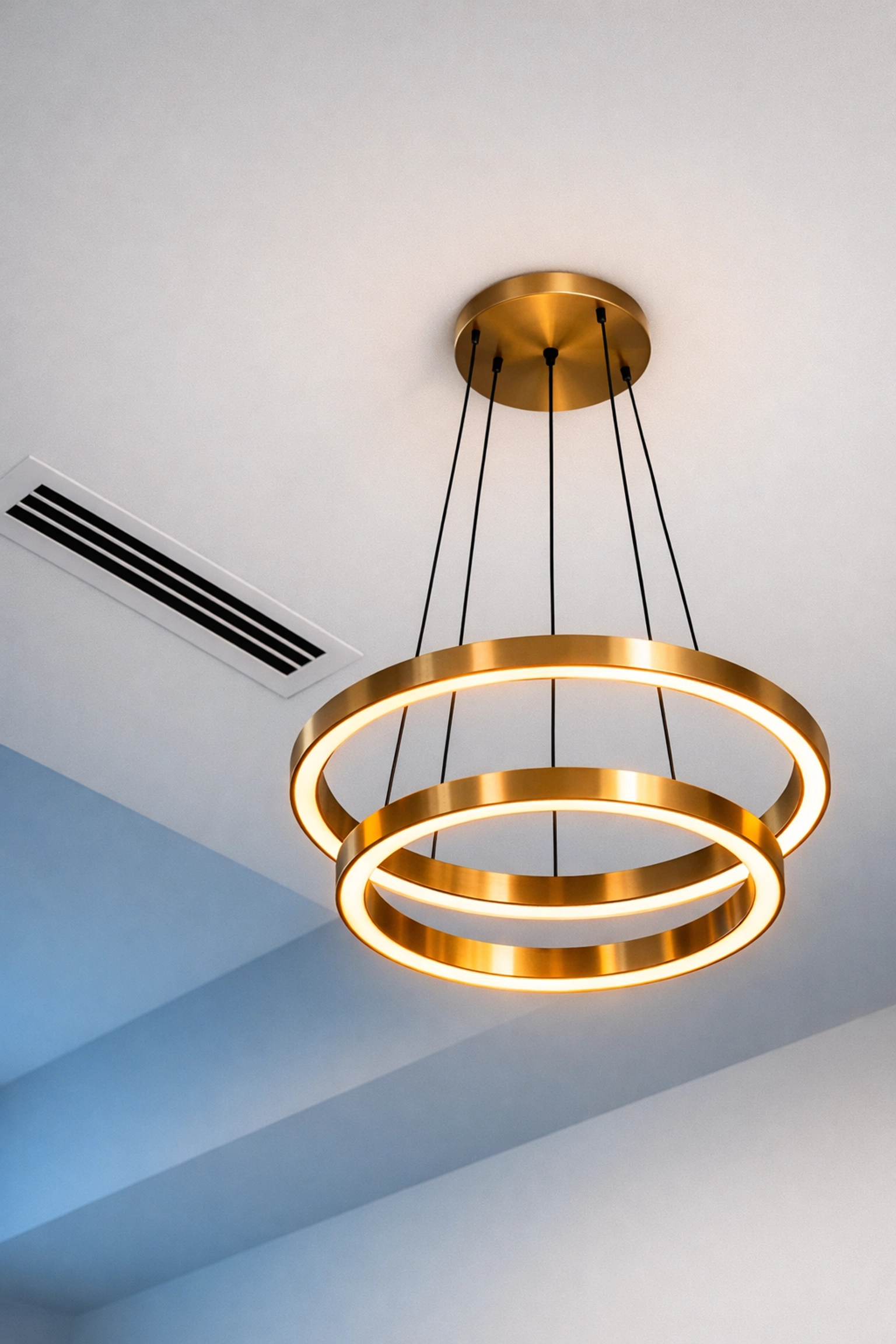 Detail of a clean ceiling vent and dust-free pendant light after a professional deep clean.