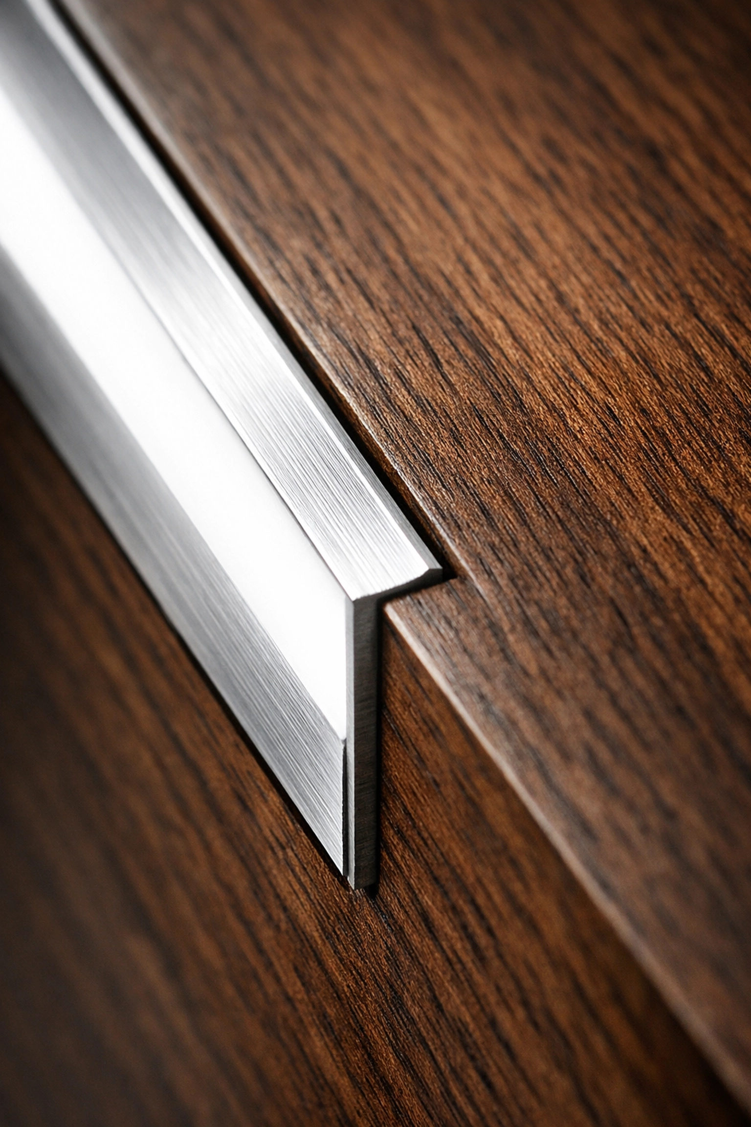 Recessed aluminum LED profile channel integrated into custom wood kitchen cabinetry.