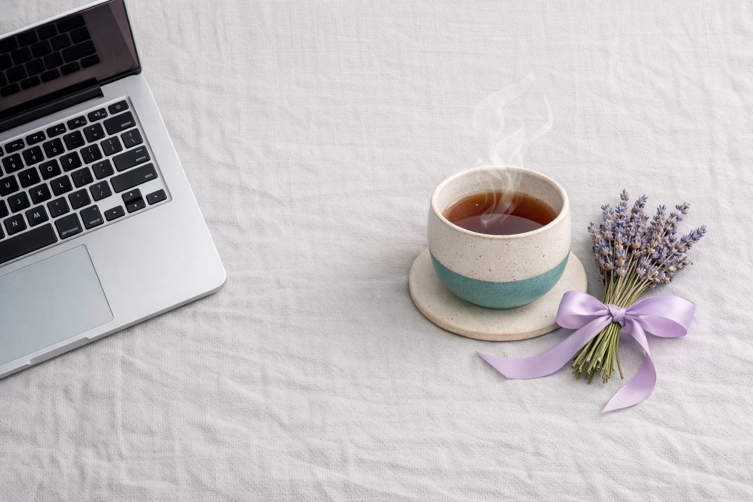 Laptop and tea representing mental resilience and work-life balance for successful UK women business owners.