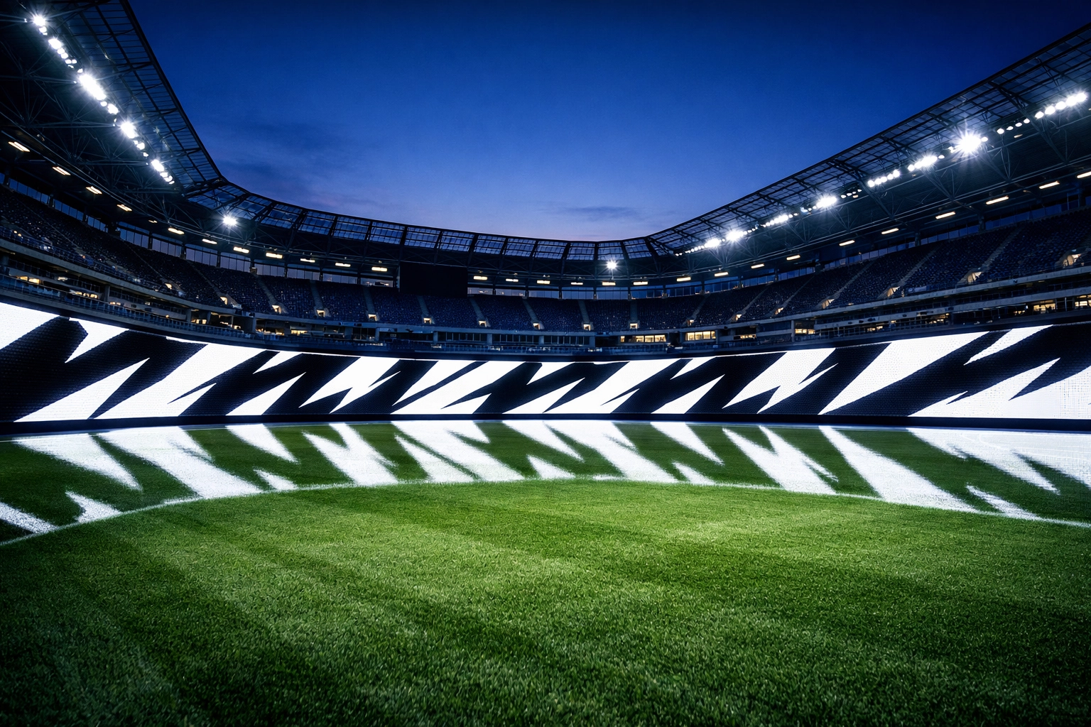 Modern sports stadium at night featuring a continuous line of digital perimeter LED advertising.