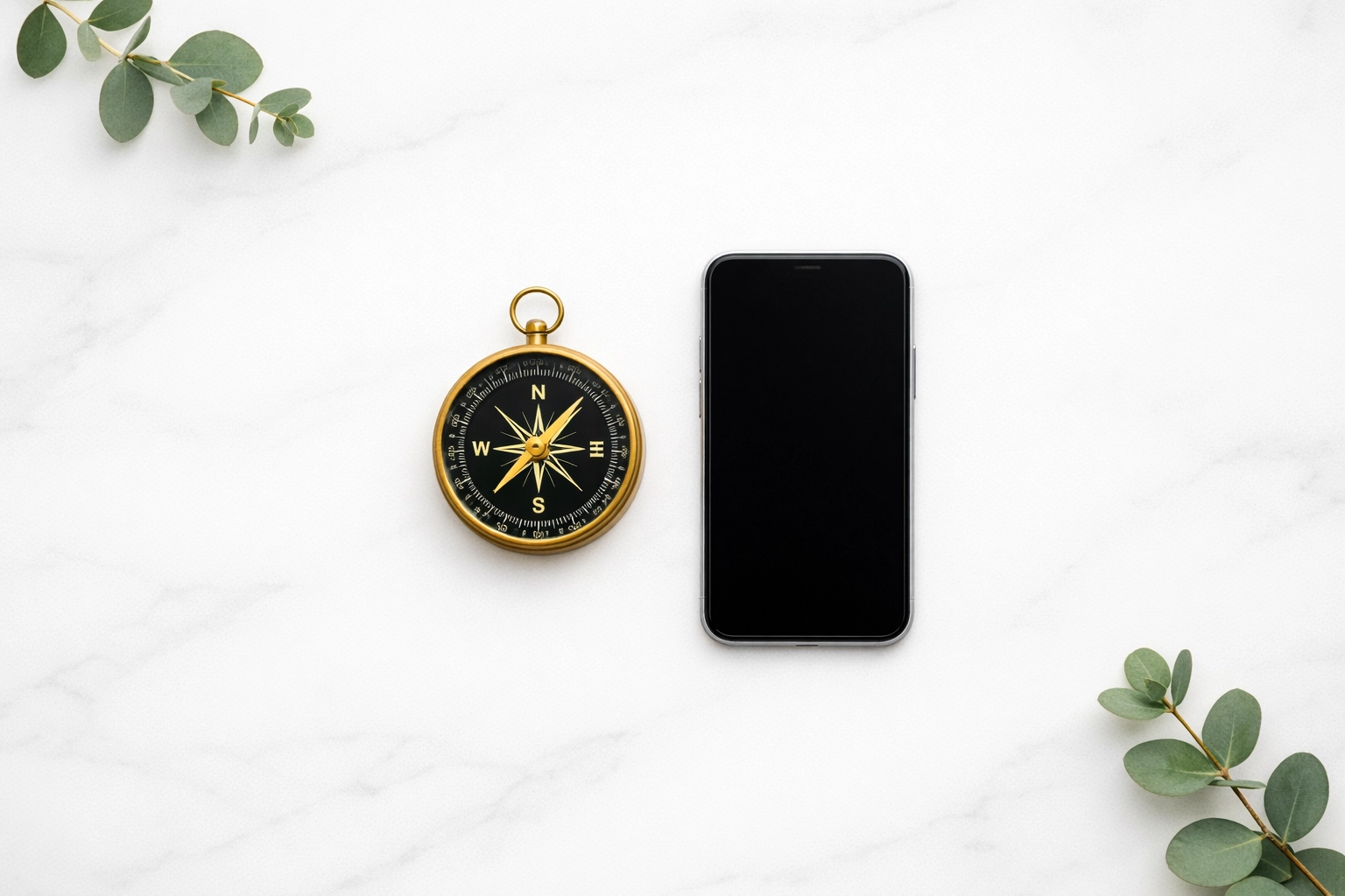 A compass and smartphone on a marble desk, illustrating curated product choices for high-trust blogs.