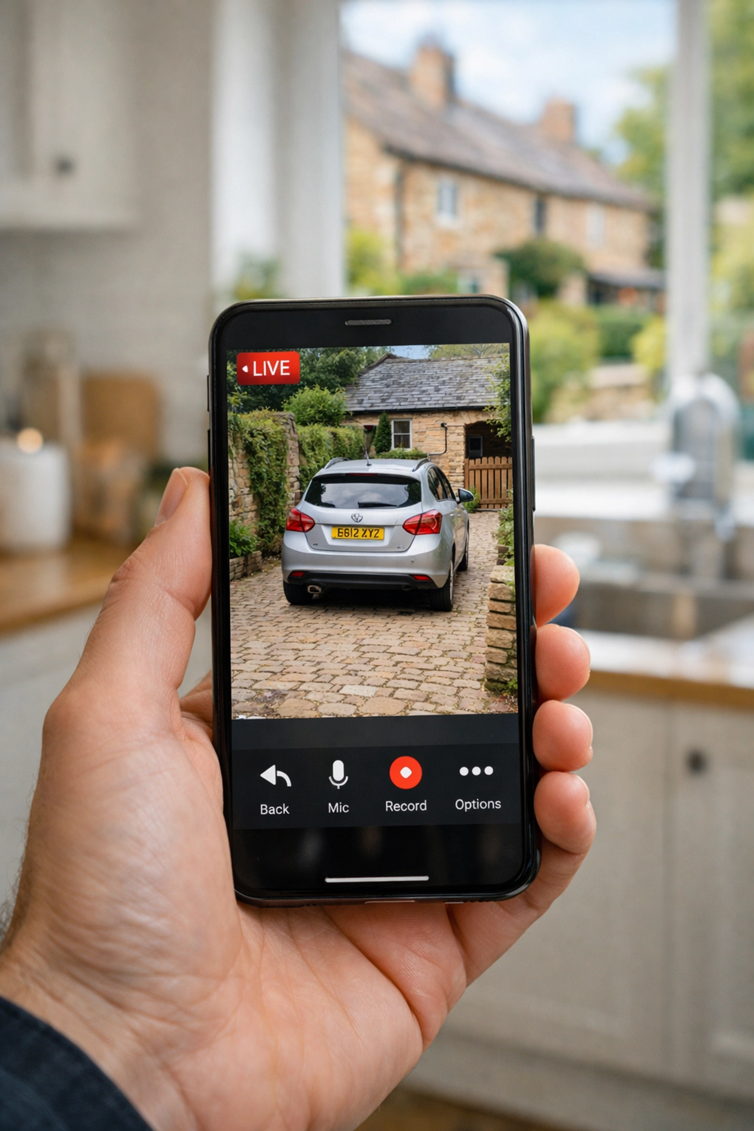Viewing a high-definition CCTV camera feed on a smartphone in a Yeovil home kitchen.