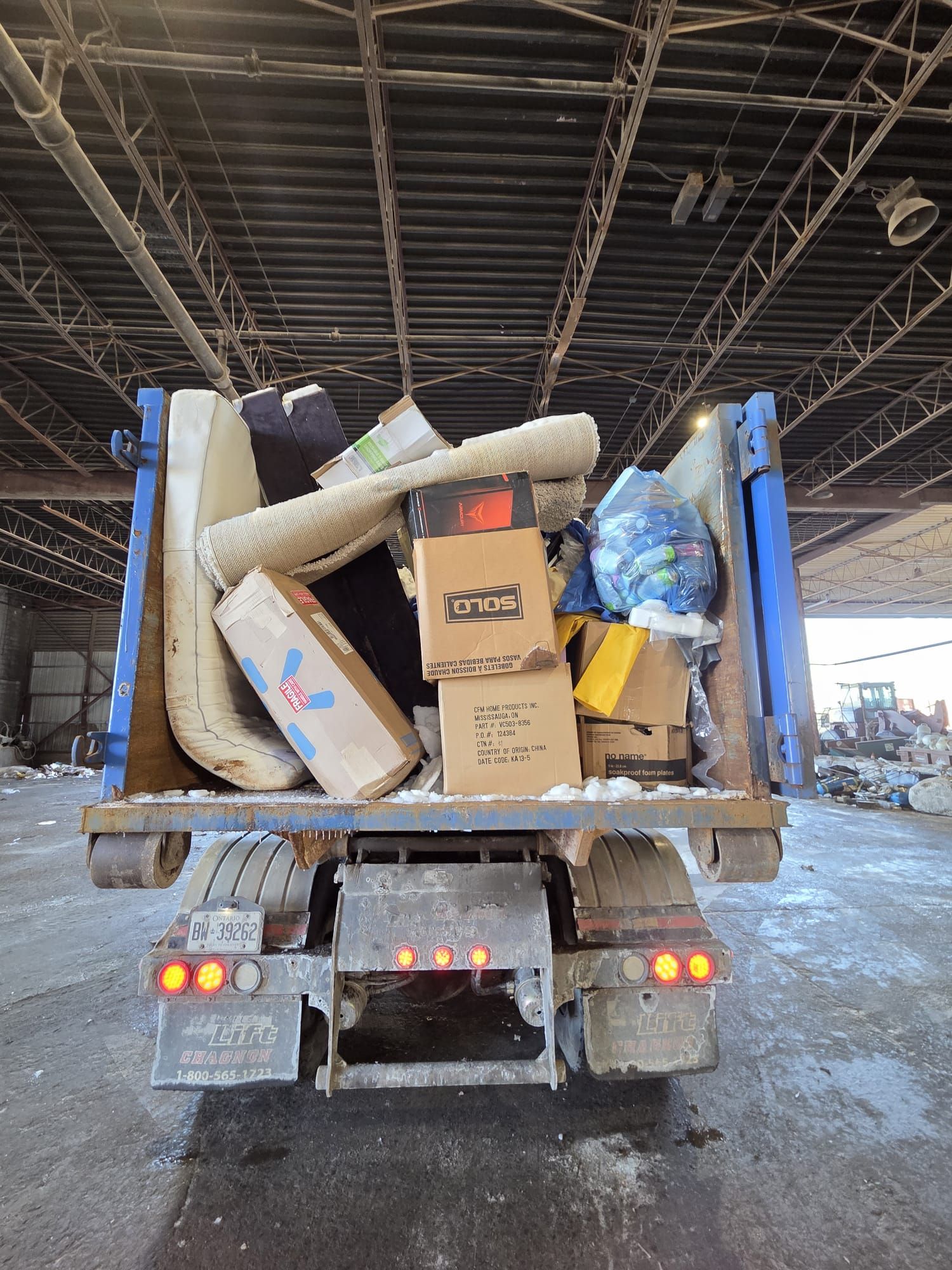 Why Professional Bin Rentals Beat DIY Junk Hauling in the GTA Fully loaded Bin4U.ca dumpster at a transfer facility demonstrating diverse waste handling