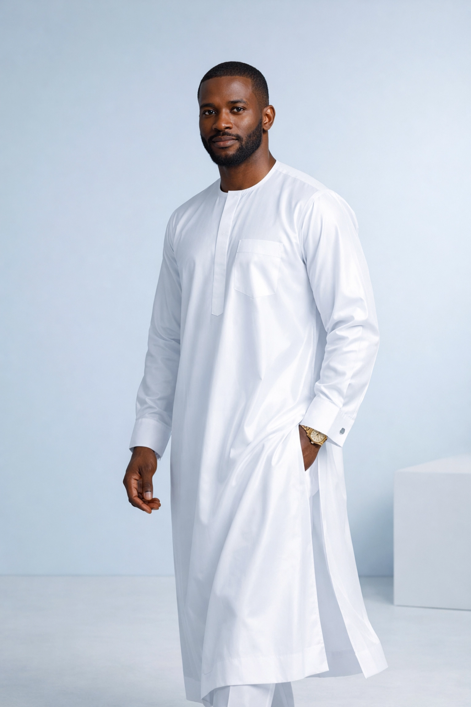 Man wearing white polished cotton kaftan showcasing elegant drape and traditional African style