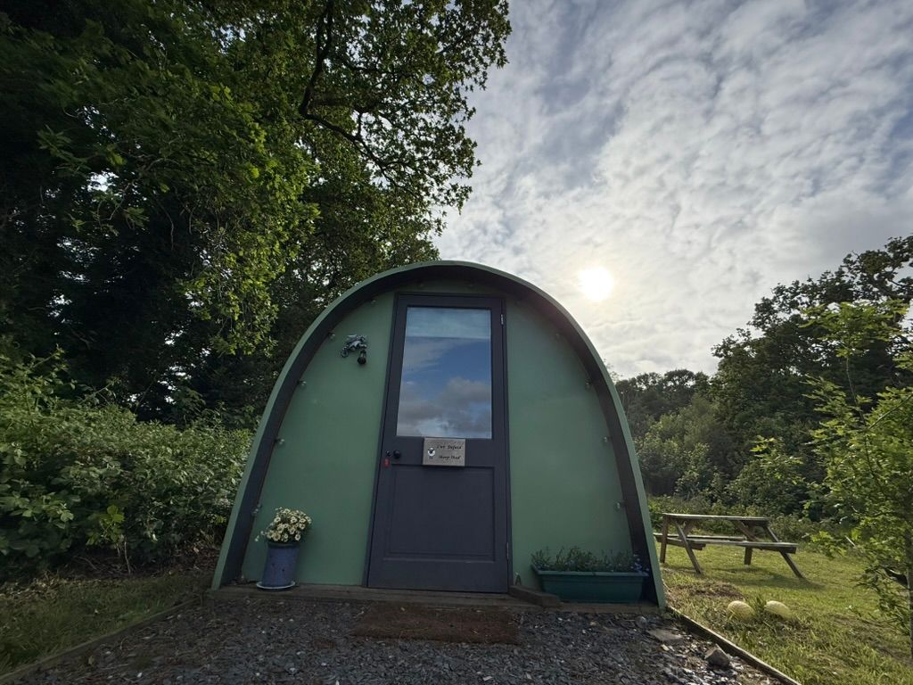 Cozy green camping pod at MotoCamp Wales — an easy upgrade for single-night stays when the weather turns.