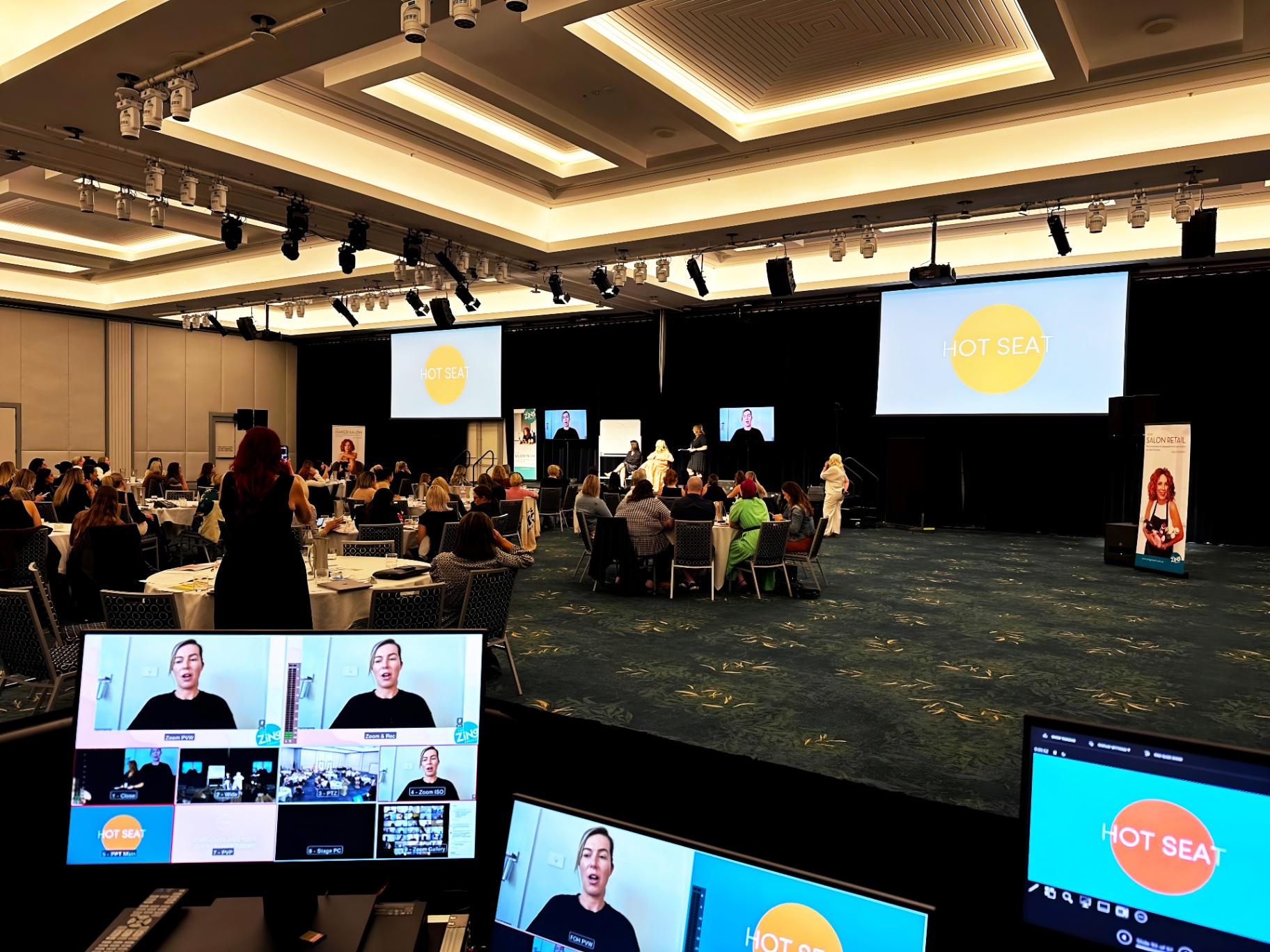 Hybrid corporate event featuring a live panel and high-definition LED wall with branding