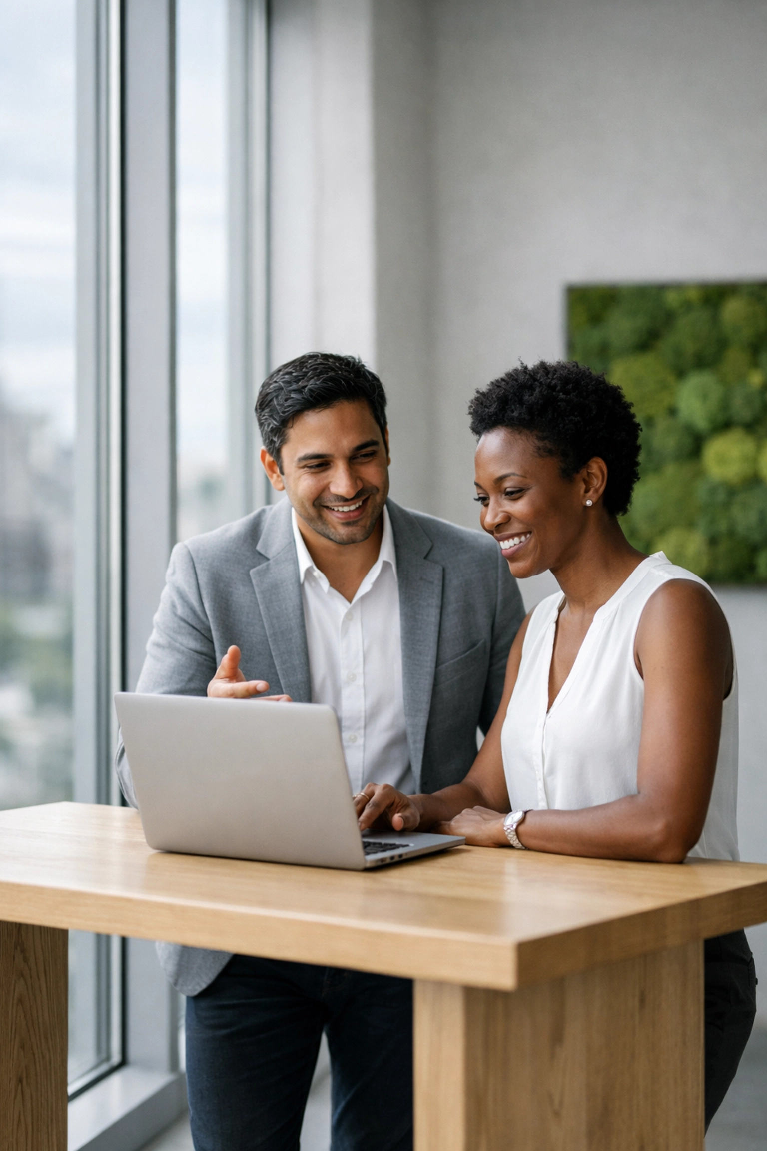 Entrepreneurs analyzing monthly bookkeeping data on a laptop to showcase financial health during VC fundraising.