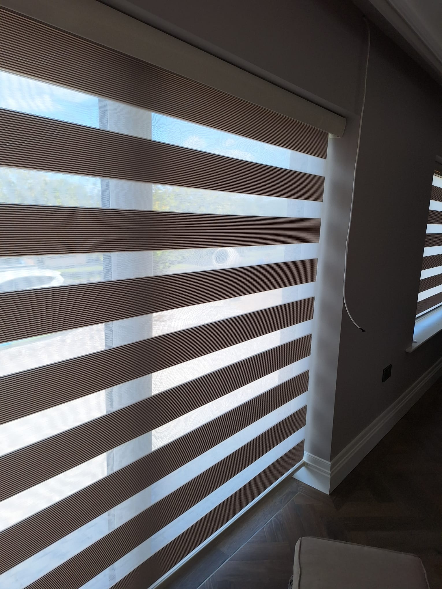 Day and night Vision Shades installed in a modern living space with alternating sheer and opaque panels