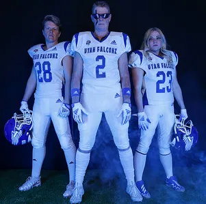 Three Utah Falconz players pose together under blue lighting during Media Day.