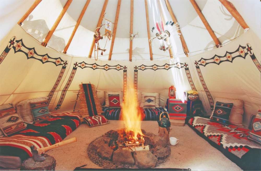Interior view of a tipi-style glamping tent at Sunset Hills Bison Ranch and Lodging