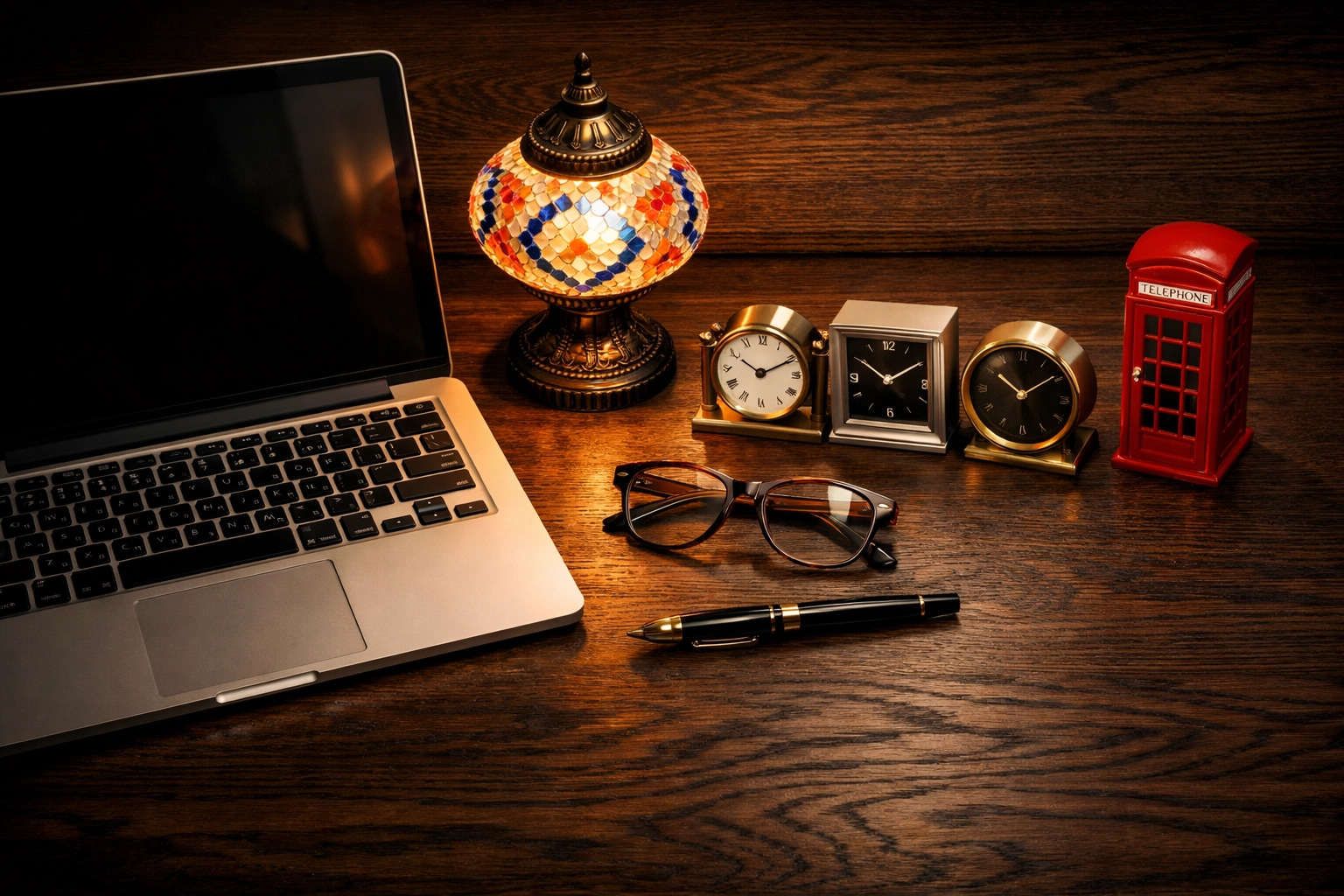 Desk with international clocks and a laptop for managing global time zones in London.