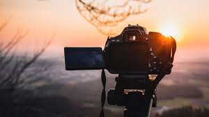 A professional camera set up outdoors at sunset