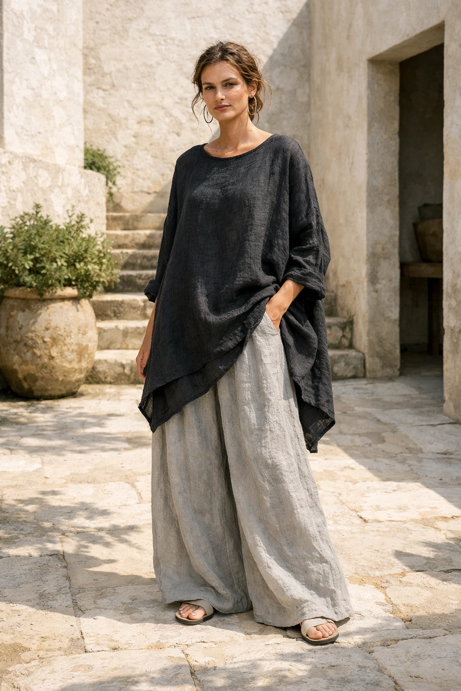 Model wearing an asymmetrical Lagenlook linen tunic and wide-leg trousers in a boho style.
