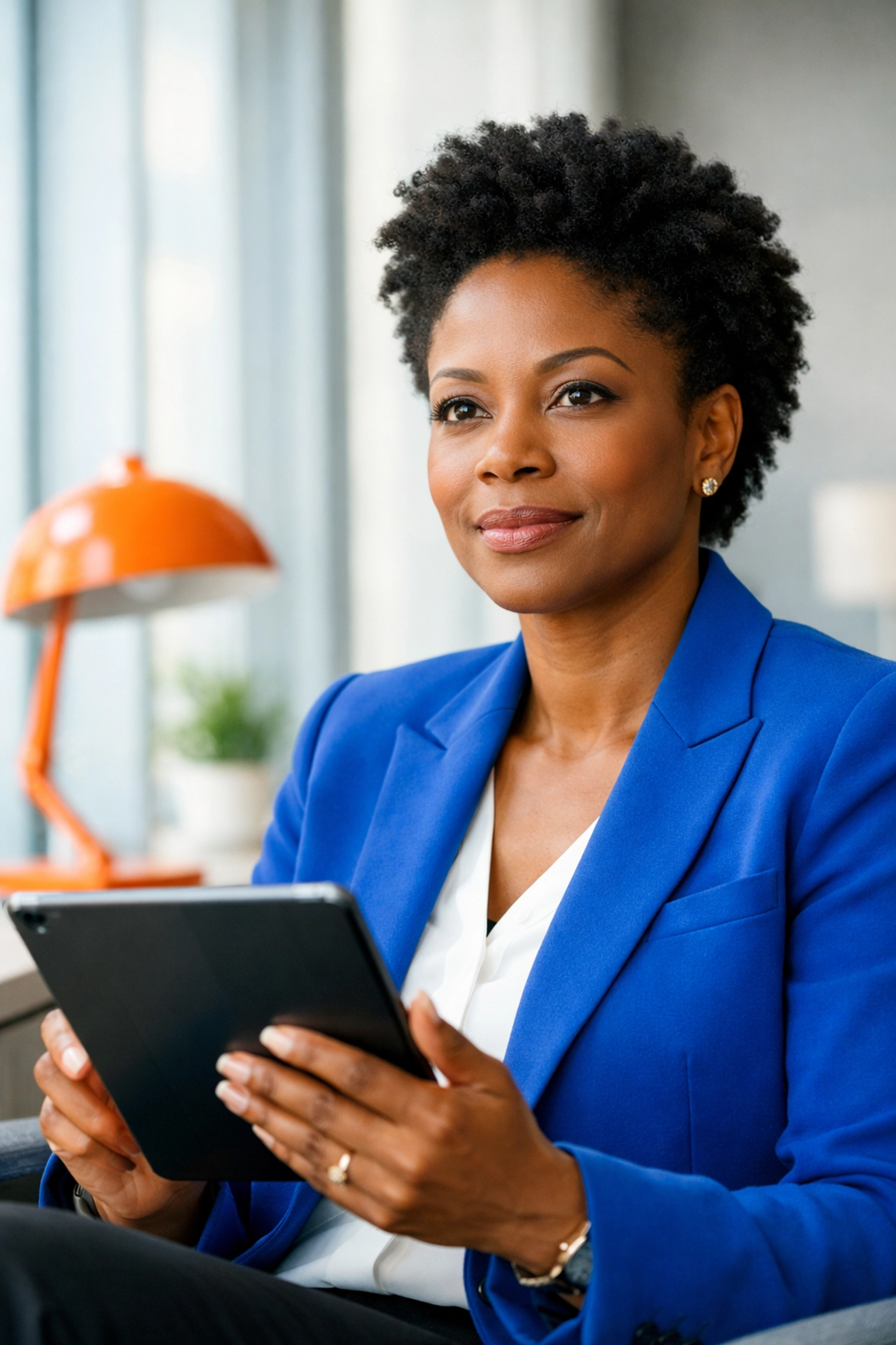 Black woman executive in a corporate office using a tablet to start a simple project management plan.